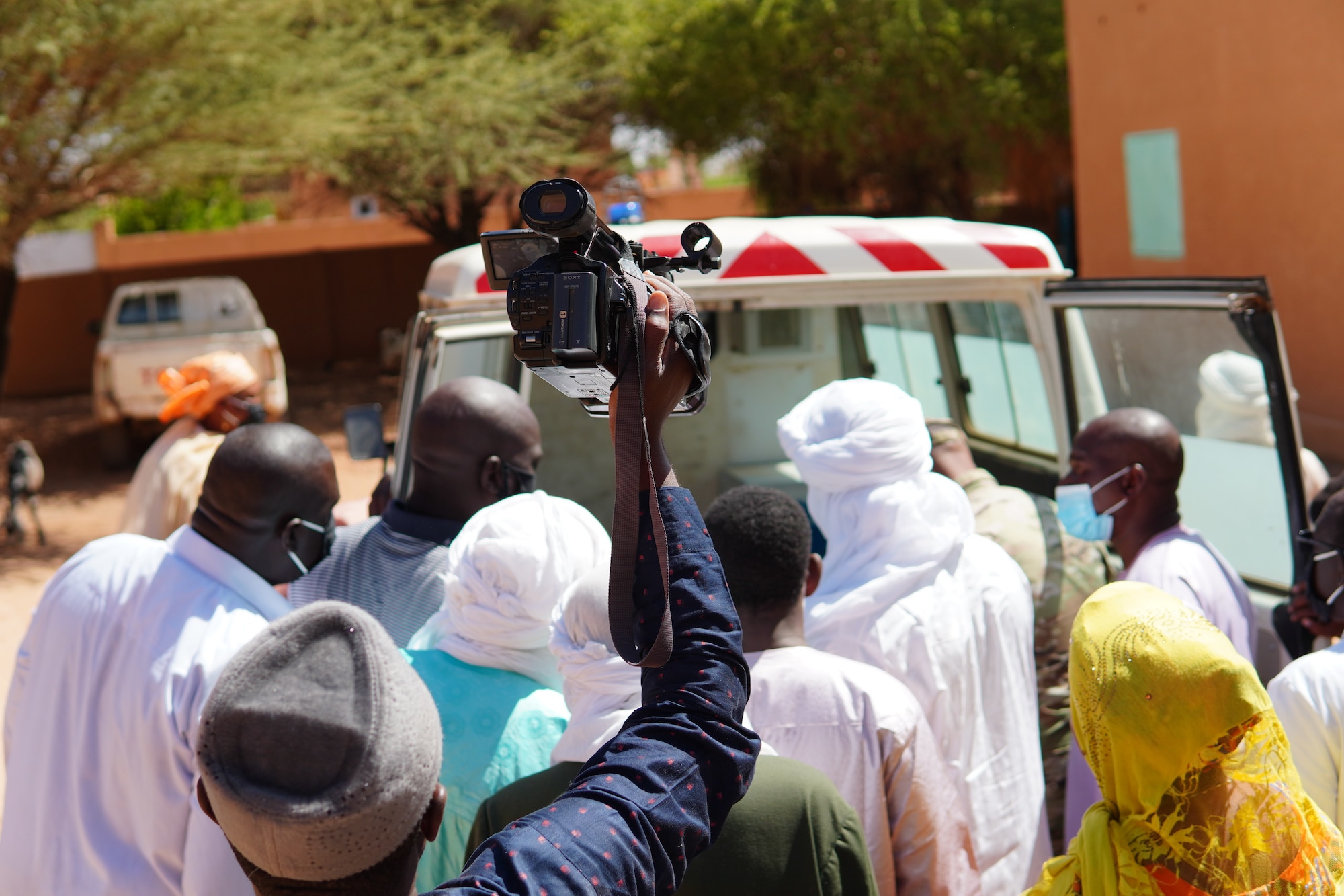 Medical staff with the District Sanitaire Commune d'Agadez clinic and local media get their first look at the newly restored ambulance delivered to the clinic in Agadez, Niger, Oct. 30, 2020. Thanks to the 724th Logistics Readiness Flight mechanics and the generosity of the Airmen of Nigerien Air Base 201, the city of Agadez now has one operable, serviceable and safe ambulance.