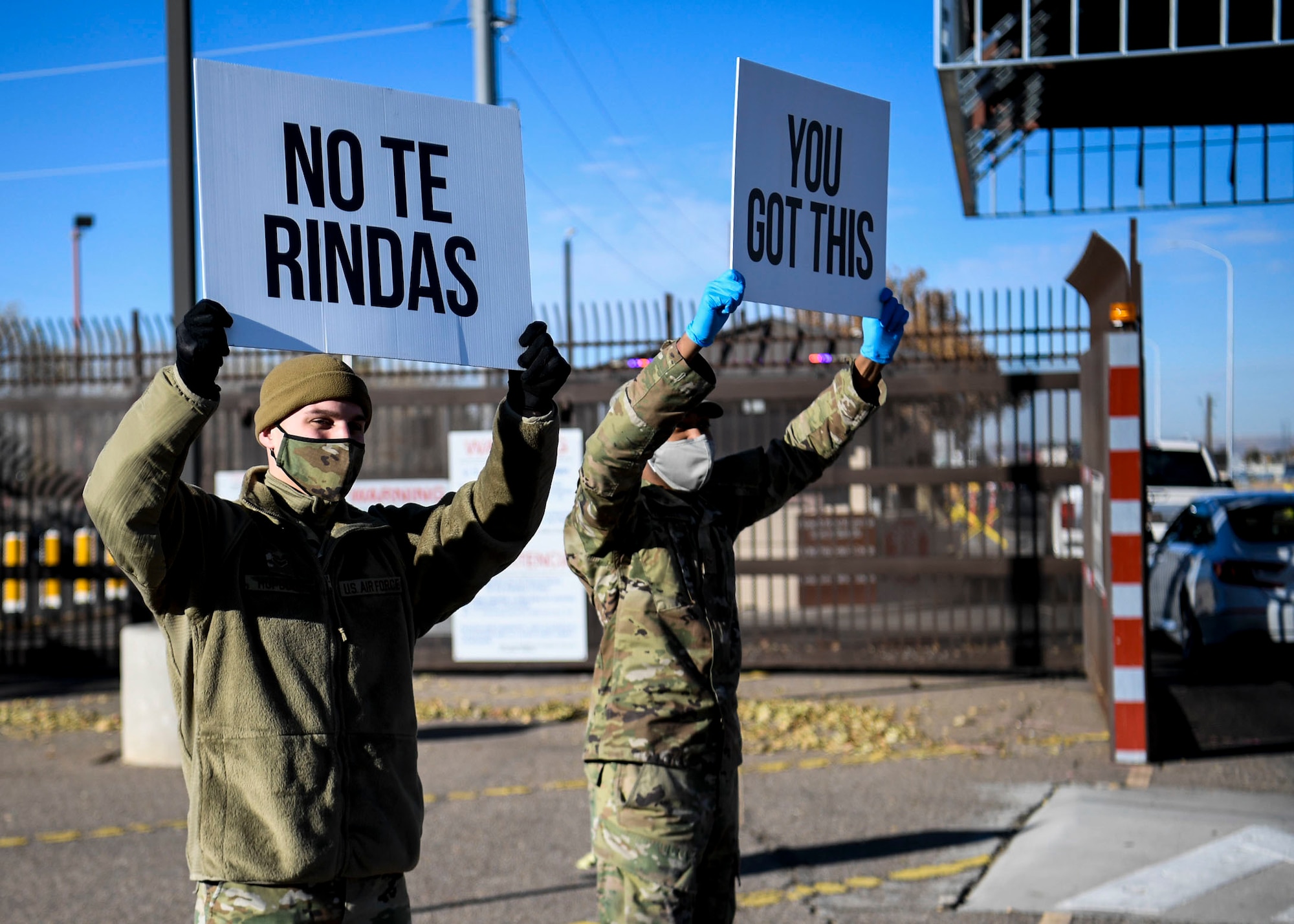 Airmen hold up signs of support.