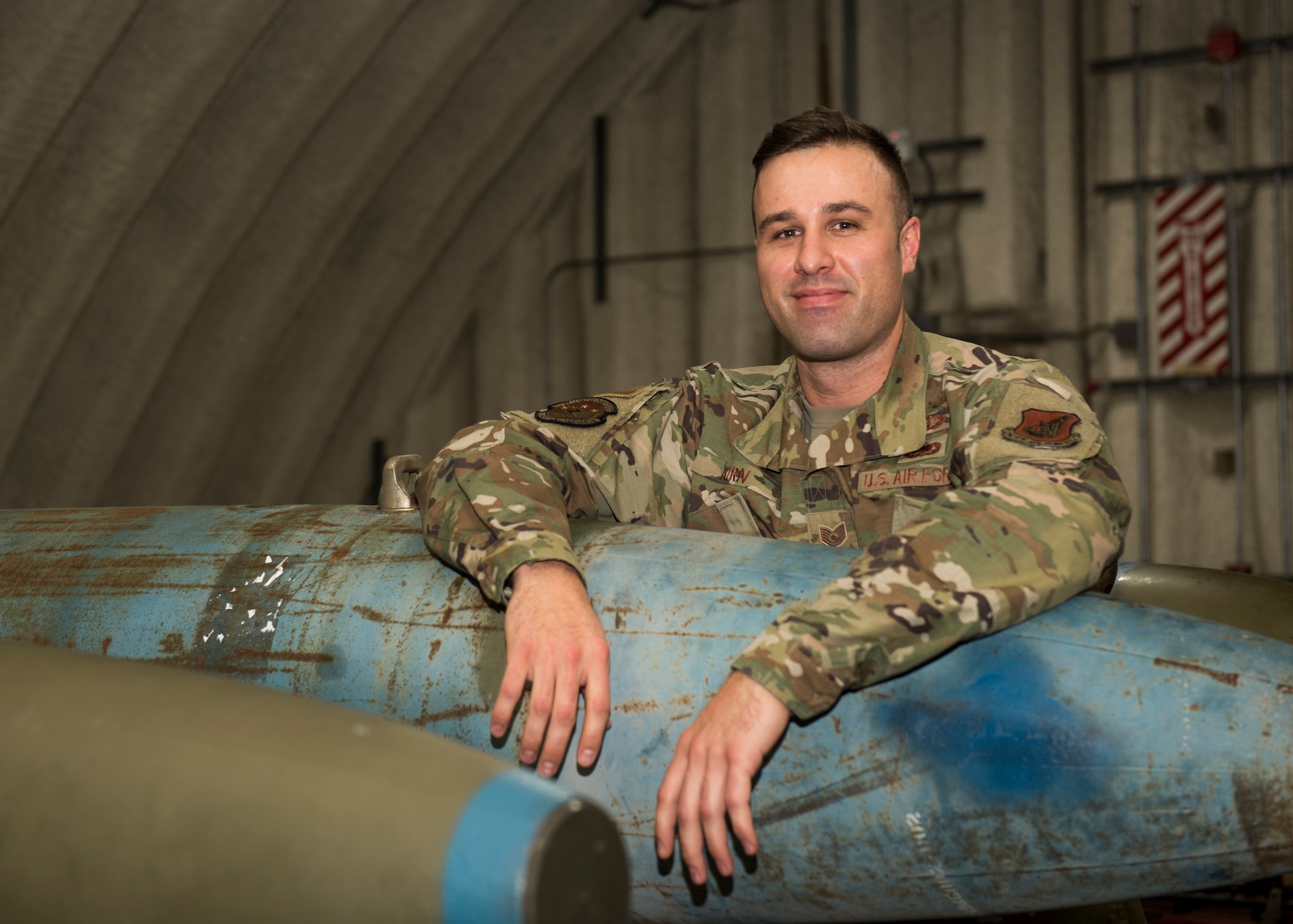 U.S. Air Force Tech. Sgt. Nicholas Kern, the 3rd Munitions Squadron training section chief, pauses for a photo in the combat munitions training facility at Joint Base Elmendorf-Richardson, Alaska, Nov. 5, 2020. Kern revamped his squadron’s training section and implemented an expanded CMT program that familiarizes ammo troops with a variety of munitions in one location.