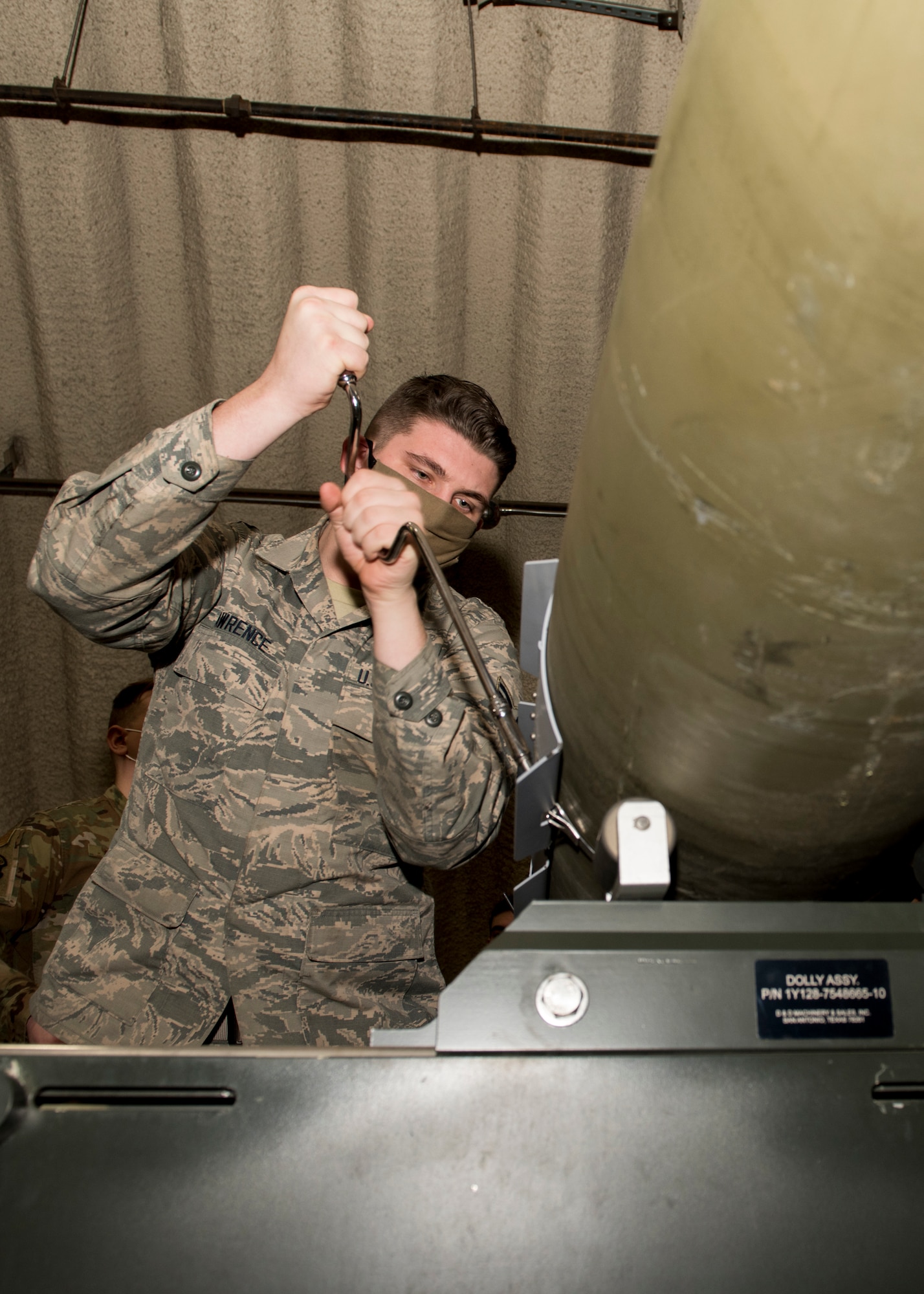 U.S. Air Force Airman 1st Class Joshua Lawrence, a 3rd Munitions Squadron stockpile management technician, installs a strake assembly onto an inert bomb during a combat munitions training class at Joint Base Elmendorf-Richardson, Alaska, Nov. 5, 2020. U.S. Air Force Tech. Sgt. Nicholas Kern, the 3rd MUNS training section chief, revamped his squadron’s training section and implemented an expanded CMT program that familiarizes ammo troops with a variety of munitions in one location.