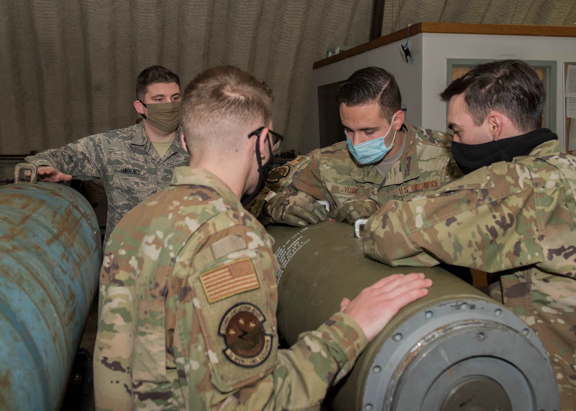 U.S. Airmen assigned to the 3rd Munitions Squadron disassemble an inert bomb during a combat munitions training class at Joint Base Elmendorf-Richardson, Alaska, Nov. 5, 2020. U.S. Air Force Tech. Sgt. Nicholas Kern, the 3rd MUNS training section chief, revamped his squadron’s training section and implemented an expanded CMT program that familiarizes ammo troops with a variety of munitions in one location.