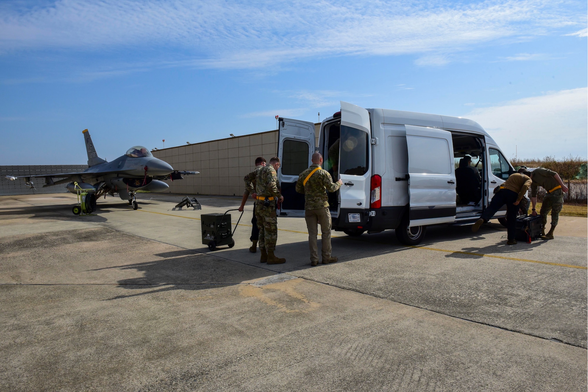 Aircraft maintainers unload equipment.