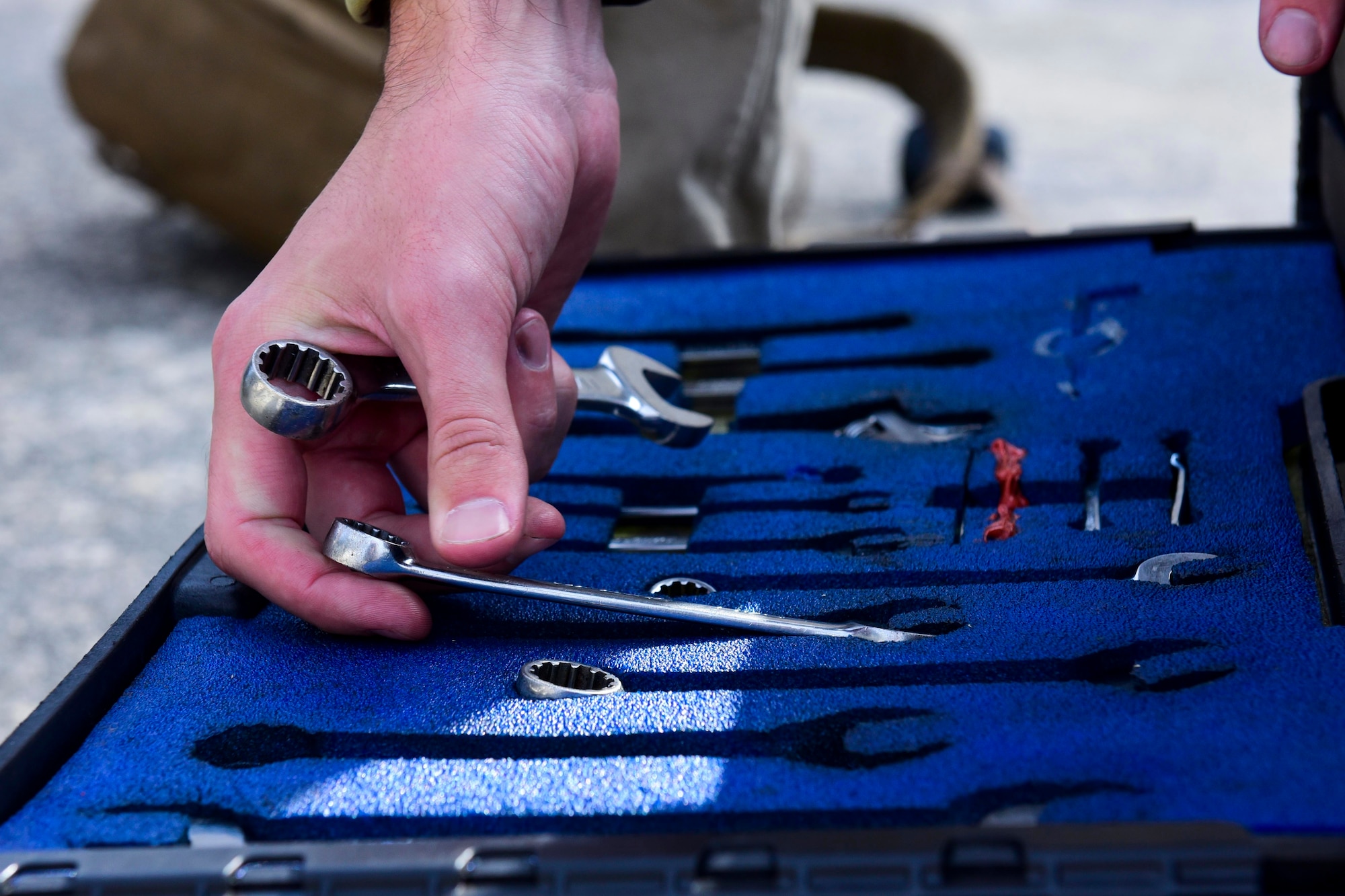 An Airman grabs a wrench.