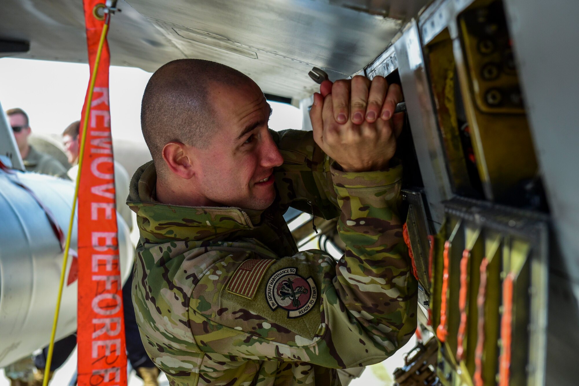 An Airman tightening a bolt.