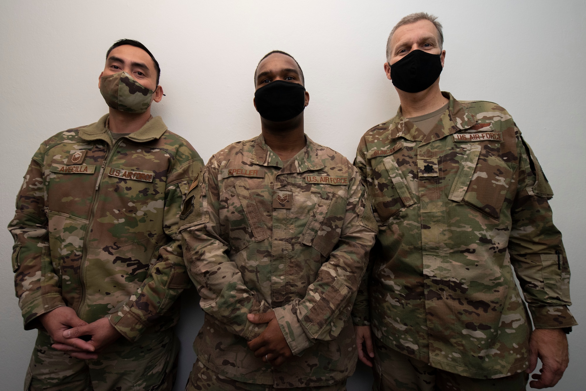 Three Airman pose for a photo.