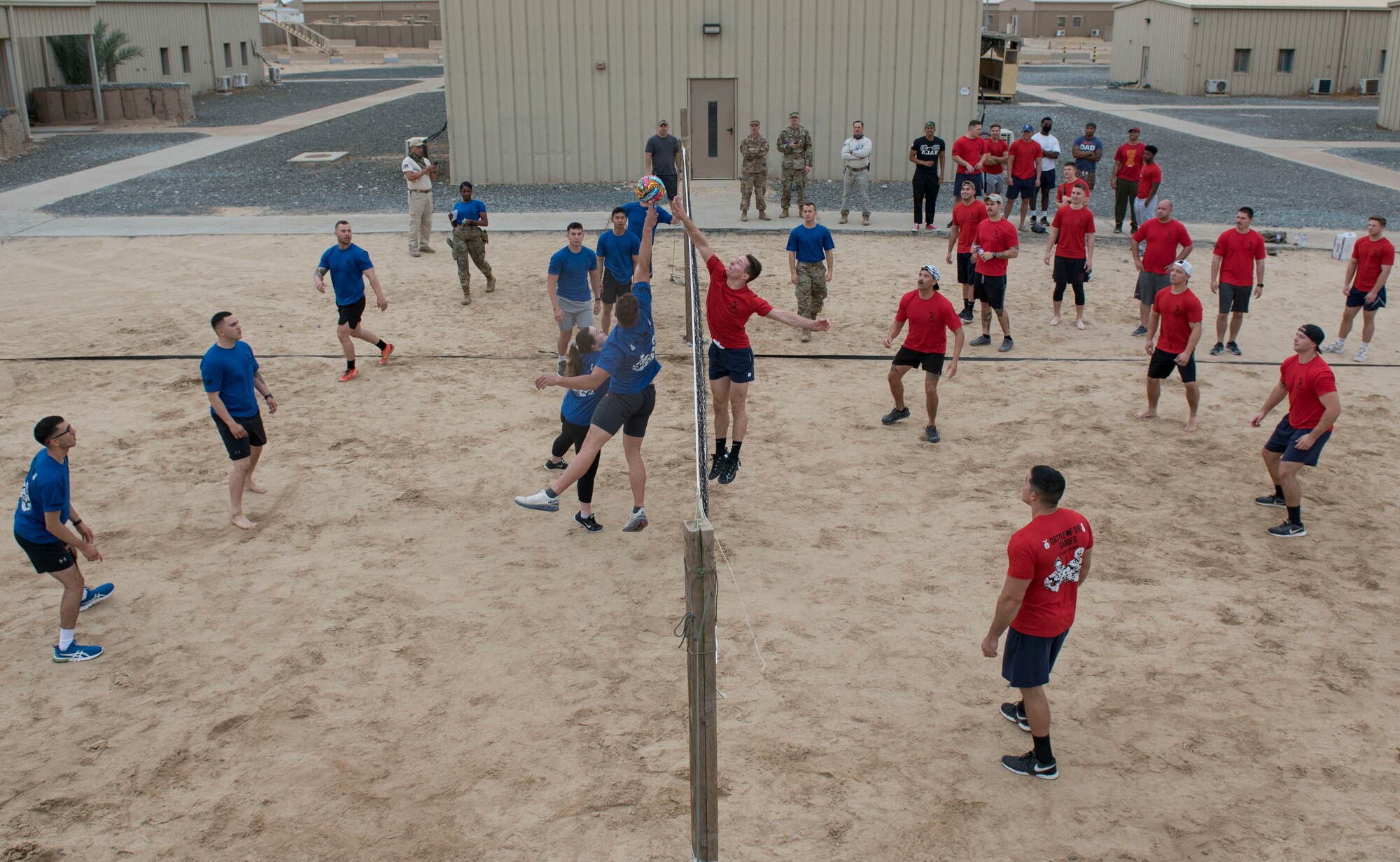 U.S. Air Force Airmen assigned to the 407th Expeditionary Security Forces Squadron and the 407th Expeditionary Civil Engineer Squadron play volleyball during the Battle of the Badges event at Ahmed Al Jaber Air Base, Kuwait, Nov. 11, 2020.