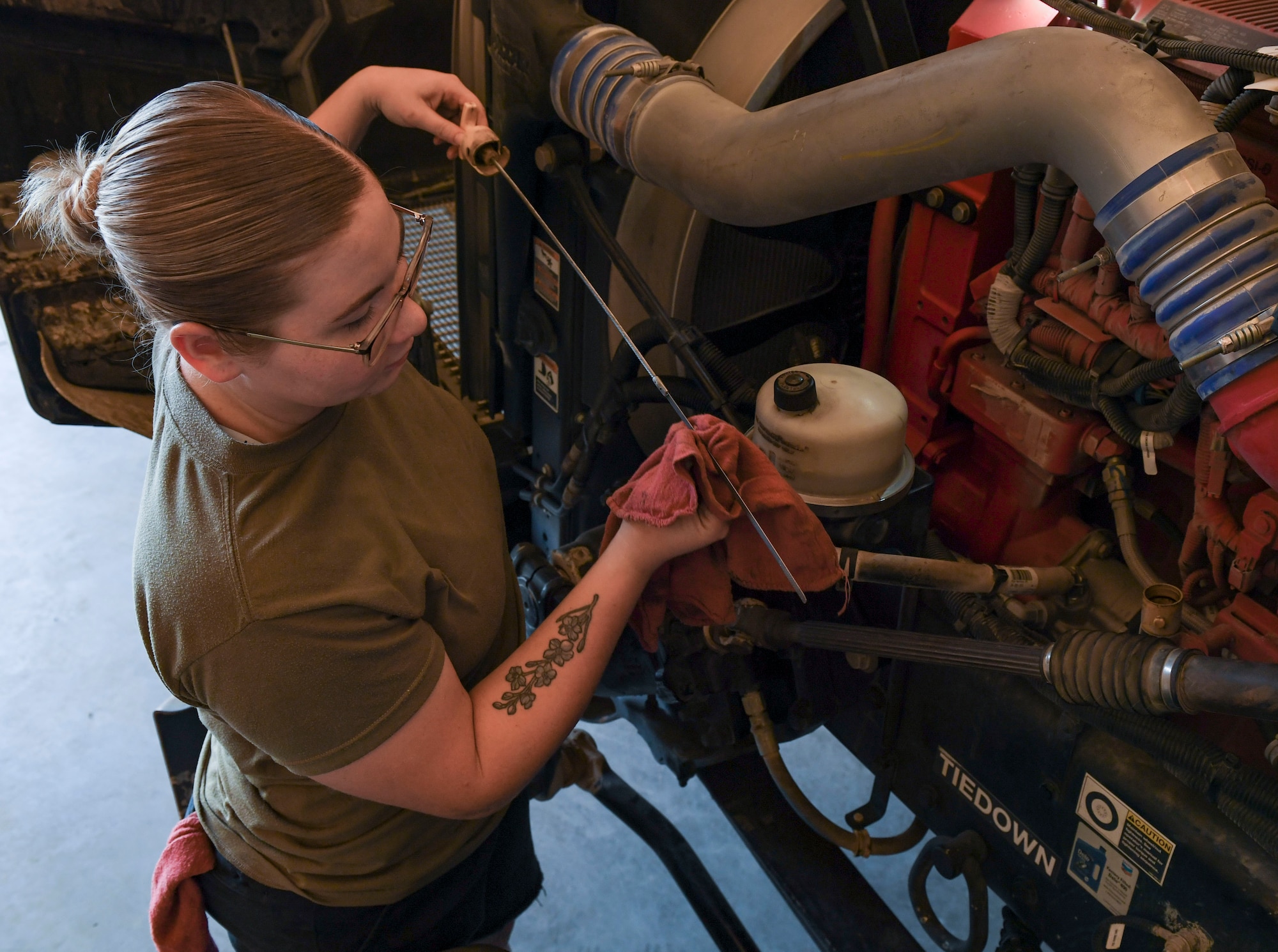 U.S. Air Force Senior Airman Hailee O’Leary, 407th Expeditionary Support Squadron logistics readiness flight refueling maintenance journeyman, checks the oil on a truck at Ahmed Al Jaber Air Base, Kuwait, Nov. 6, 2020.