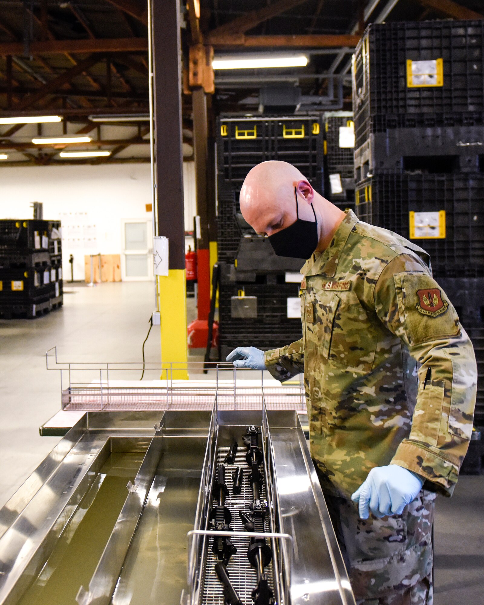 U.S. Air Force Tech. Sgt. Kyle Deconnick, 52nd Logistics Readiness Squadron NCOIC of Individual Protective Equipment, cleans an M4 using a new ultrasonic weapons cleaner at Spangdahlem Air Base, Germany, Nov. 9, 2020. Deconnick led the way to acquiring the machine to enhance the weapons cleaning process and save man hours. (Air Force photo by Senior Airman Chanceler Nardone)