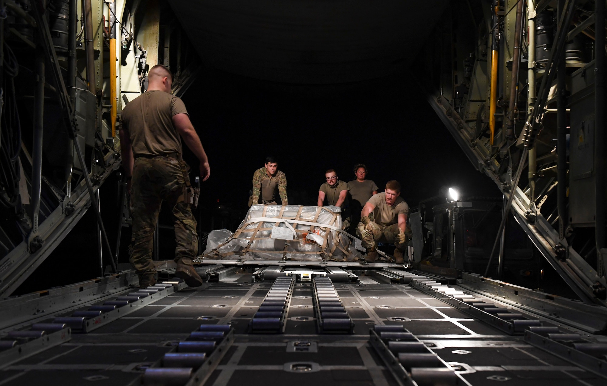 U.S. Air Force Airmen load cargo onto a C-130 Hercules at Ali Al Salem Air Base, Kuwait Oct. 30, 2020.