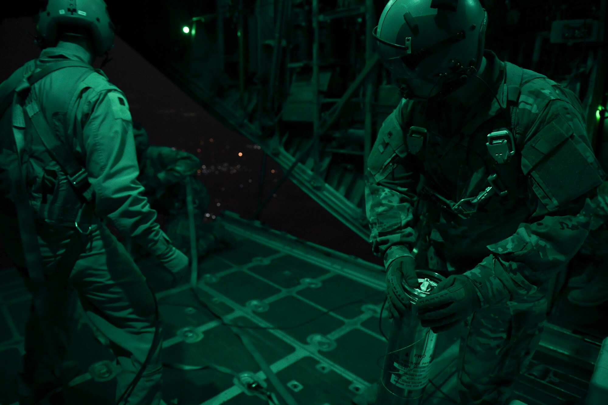 U.S. Air Force Airmen prepare to drop illumination flares from a C-130 Hercules Oct. 30, 2020.