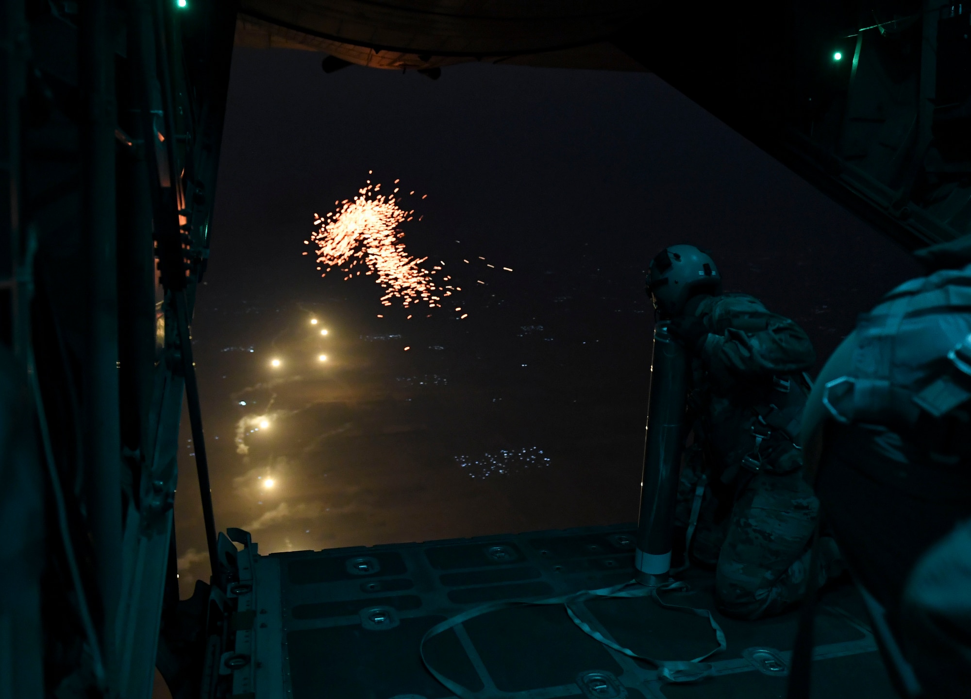 A U.S. Air Force Airman prepares to drop illumination flares from a C-130 Hercules Oct. 30, 2020.