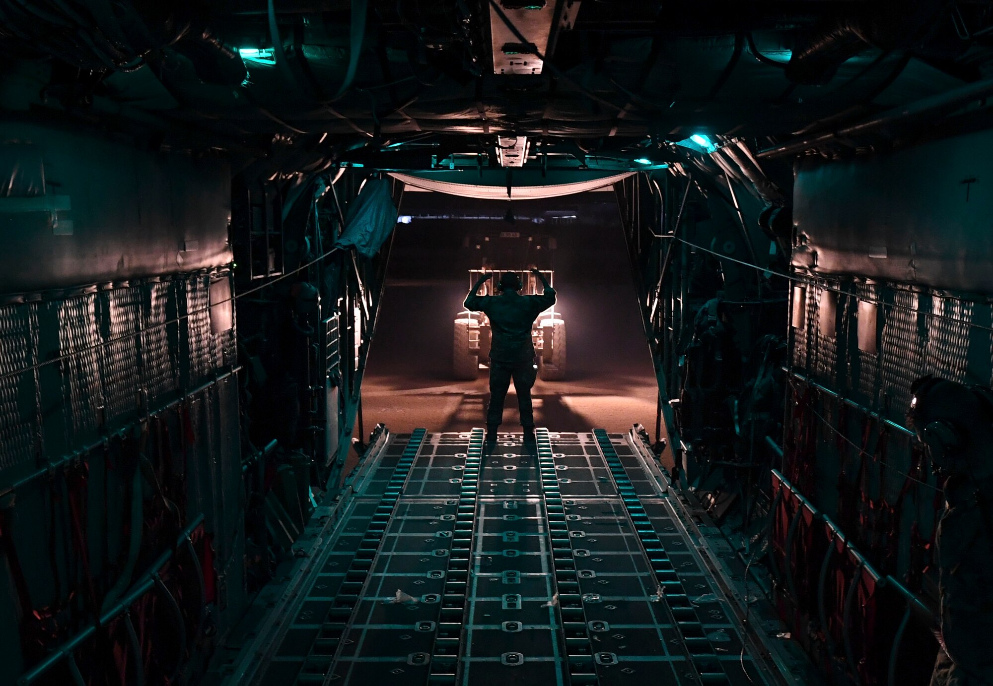 A U.S. Air Force Airman guides a forklift to unload cargo from a C-130 Hercules Oct. 30, 2020.