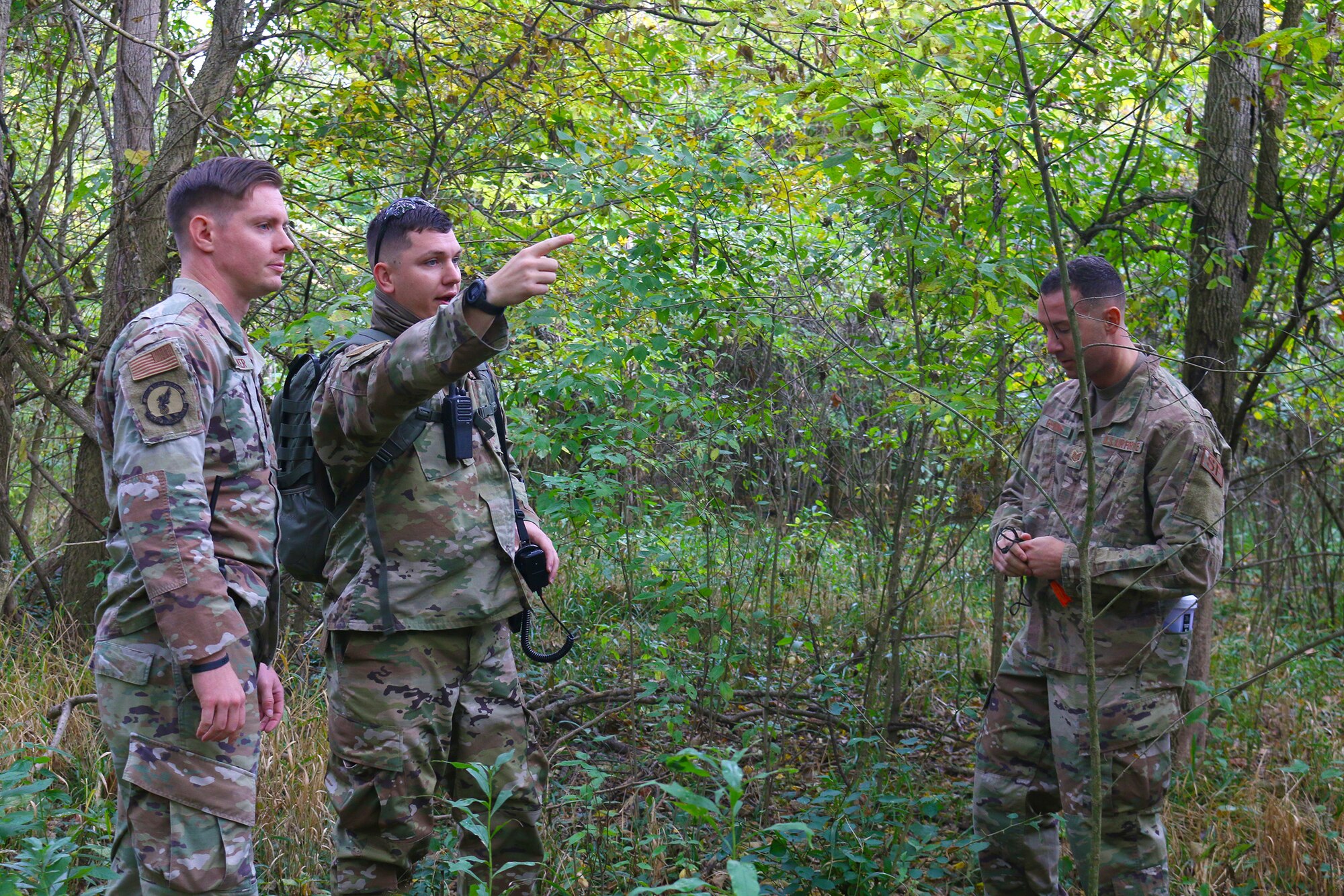 Members of the 445th Security Forces Squadron discuss search tactics while participating in combat search and rescue training, Oct. 4, 2020 at Wright-Patterson AFB, Ohio.  The Airmen acted as opposing forces, OPFOR, during the training conducted for Airmen assigned to the 89 Airlift Squadron and the 375th Air Evacuation Training Squadron.