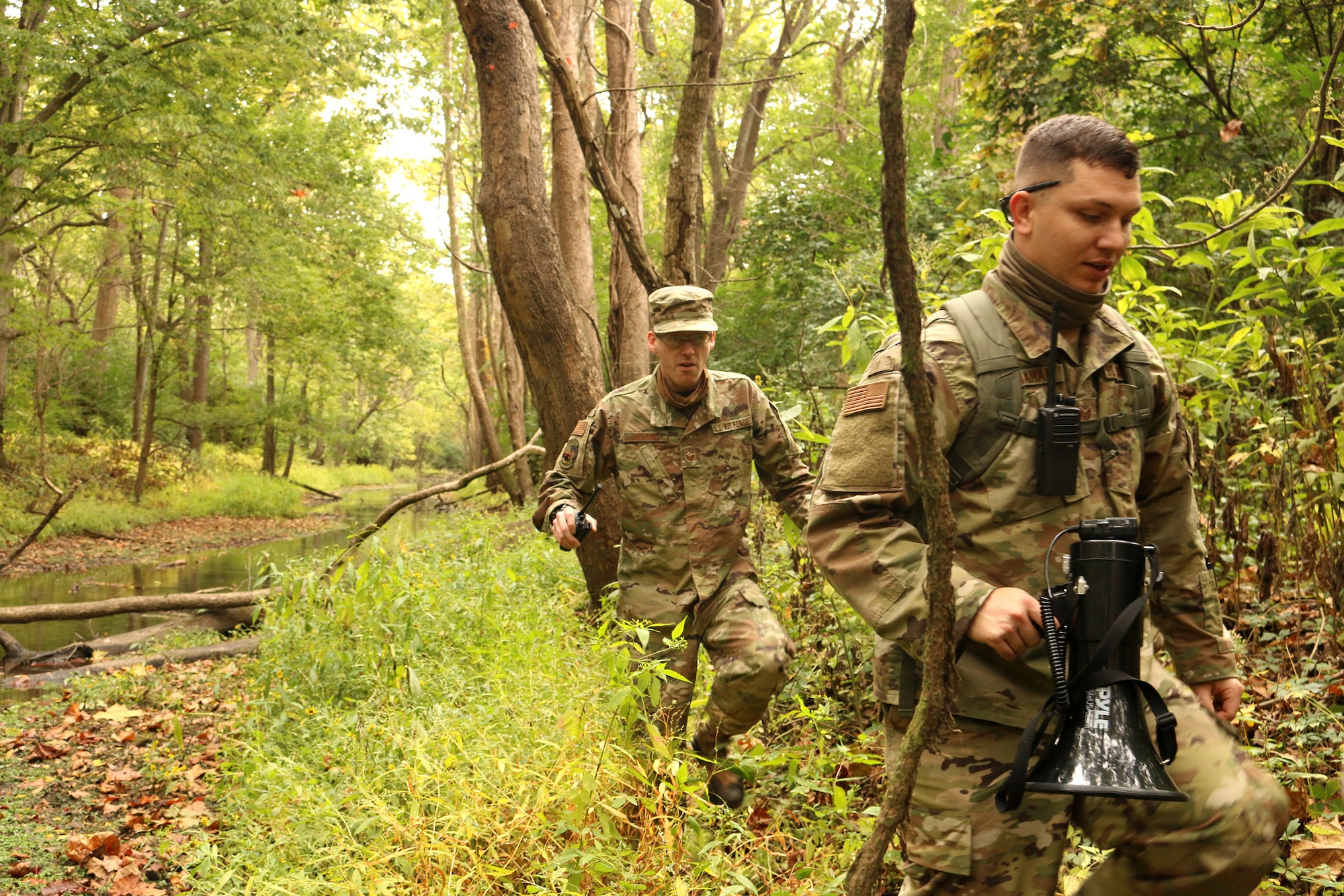 Members of the 445th Security Forces Squadron discuss search tactics while participating in combat search and rescue training, Oct. 4, 2020 at Wright-Patterson AFB, Ohio.  The Airmen acted as opposing forces, OPFOR, during the training conducted for Airmen assigned to the 89 Airlift Squadron and the 375th Air Evacuation Training Squadron.