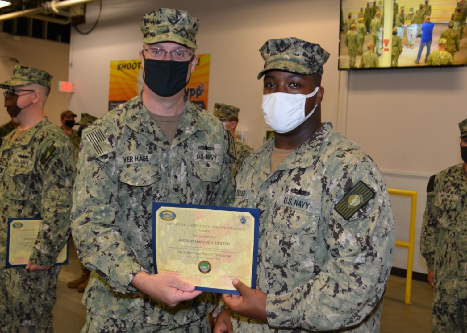 Rear Adm. Eric Ver Hage, Commander, Navy Regional Maintenance Center (left) presents a Navy Afloat Maintenance Training Strategy (NAMTS) Navy Enlisted Classification (NEC) Certificate to EM2 Marcus J. Dexter at Southeast Regional Maintenance Center (SERMC).