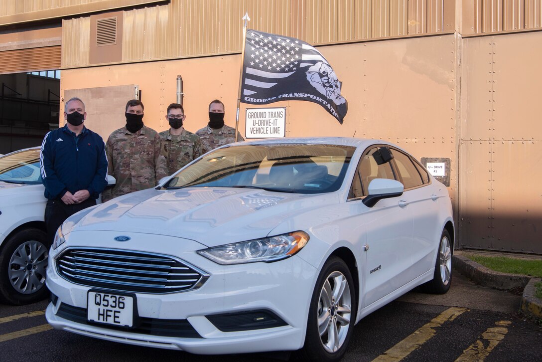 U.S. Airmen with the 100th Logistics Readiness Squadron ground transportation section stand next to a U-Drive-It vehicle, a concept they implemented at the beginning of July, at Royal Air Force Mildenhall, England, Nov. 12, 2020. The U-Drive-It system protects Airmen from coronavirus and saves customers time due to the contactless nature of its vehicle pickup and drop-off process. (U.S. Air Force photo by Airman 1st Class Joseph Barron)