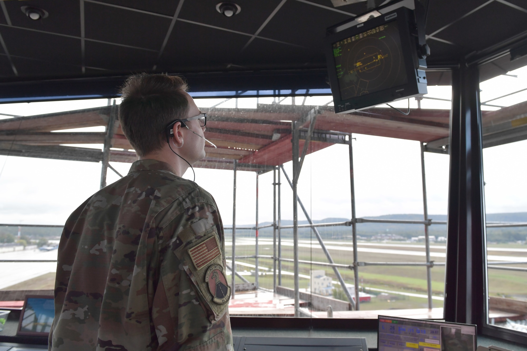 An Airman staring at a radar screen.