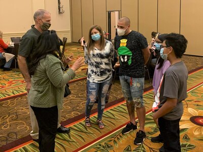 U.S. Army South Commanding General Maj. Gen. Daniel R. Walrath and his wife (left) encourage family members in attendance at the Strong Bonds couples training Nov. 7 at the Hyatt Regency Hill Country Resort in San Antonio, Texas. Strong Bonds is a chaplain-led program that assists commanders in building individual resiliency by strengthening the Army family.