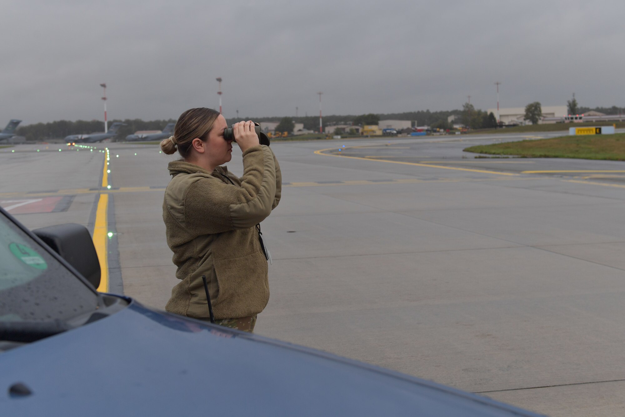 An Airman holding binoculars.