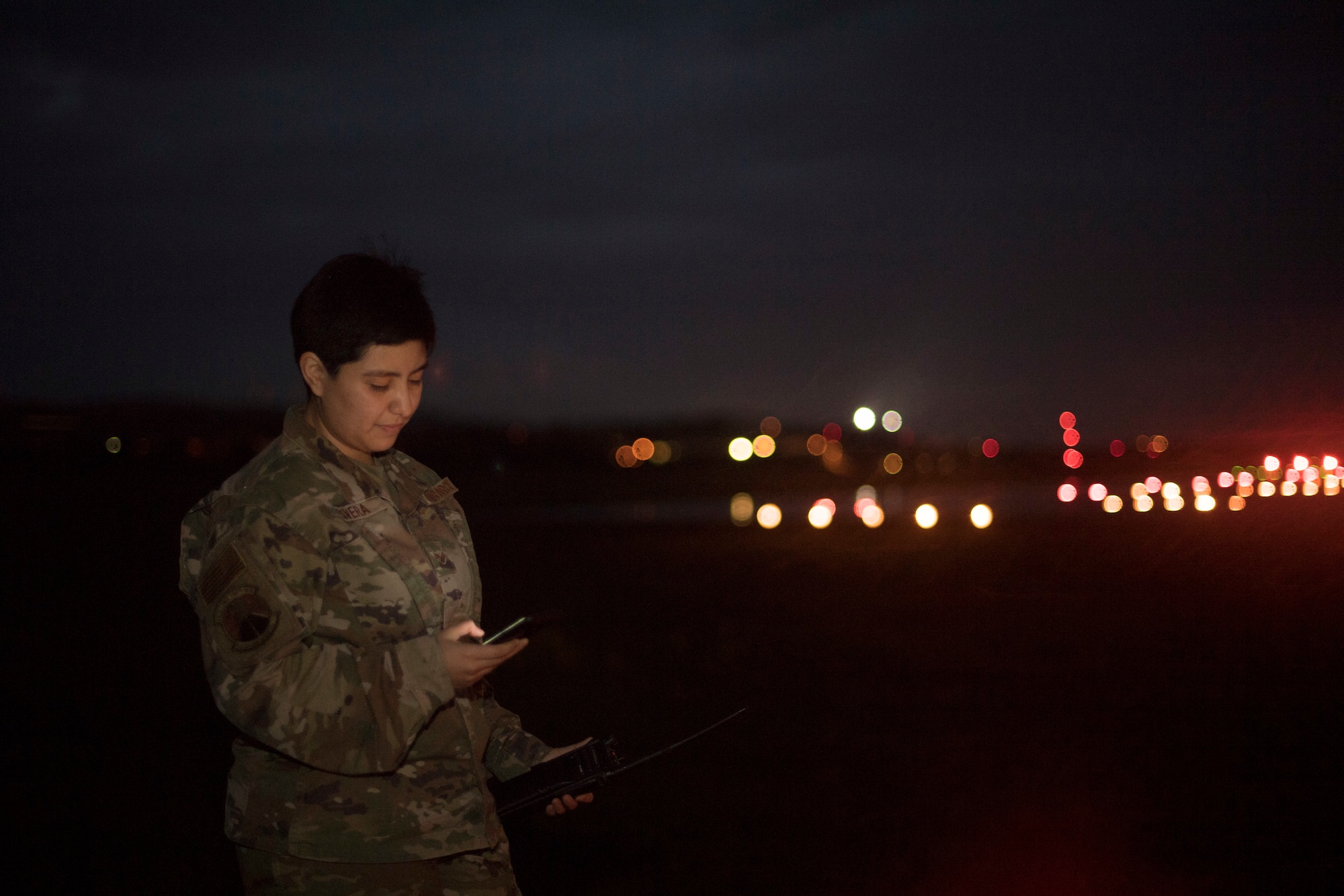An Airman holding a cell phone.