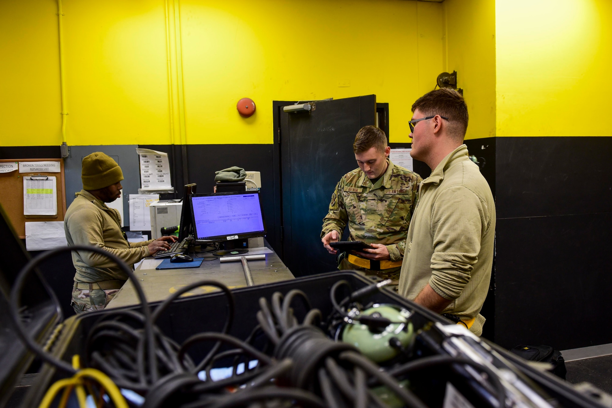 Airmen inspecting maintenance equipment.