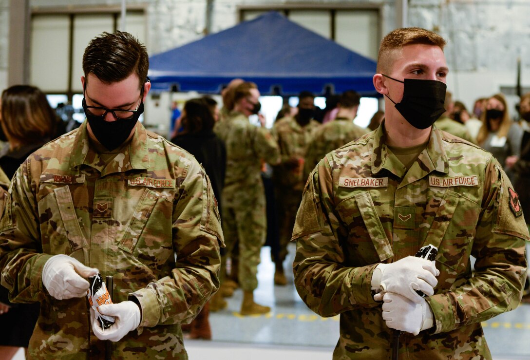 Honor Guard Airmen receive Halloween candy delivered by 88th Air Base Wing senior leader spouses during their base tour Oct. 30. Tour attendees got a chance to familiarize themselves with the diverse workspaces and missions of Wright-Patterson Air Force Base and get to know its Airmen along the way.