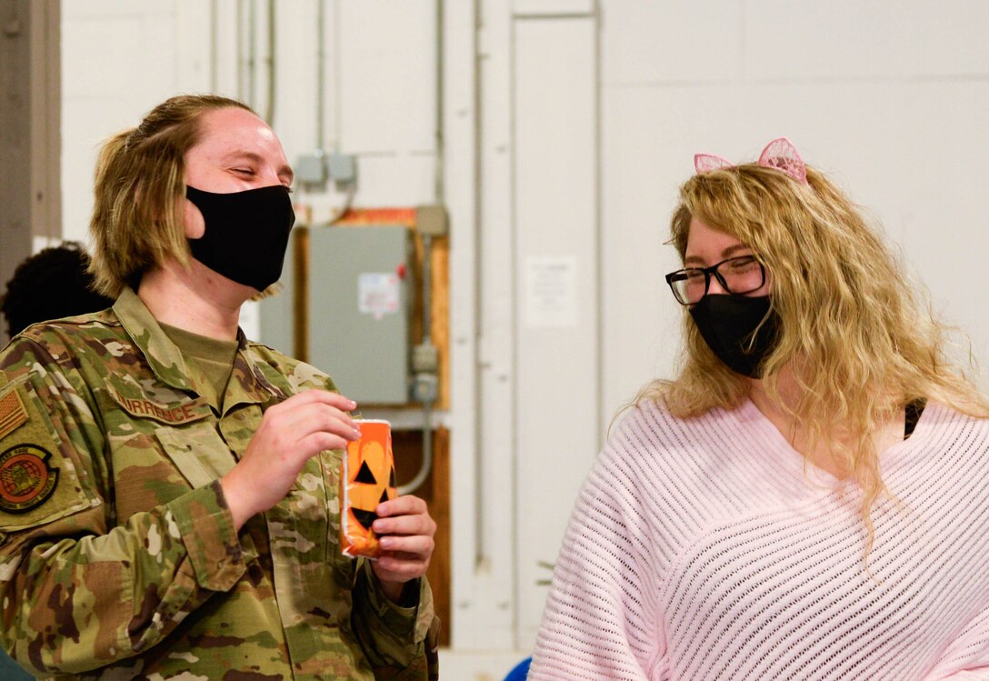 Honor Guard Airmen receive Halloween candy delivered by 88th Air Base Wing senior leader spouses during their base tour Oct. 30. Tour attendees got a chance to familiarize themselves with the diverse workspaces and missions of Wright-Patterson Air Force Base and get to know its Airmen along the way.