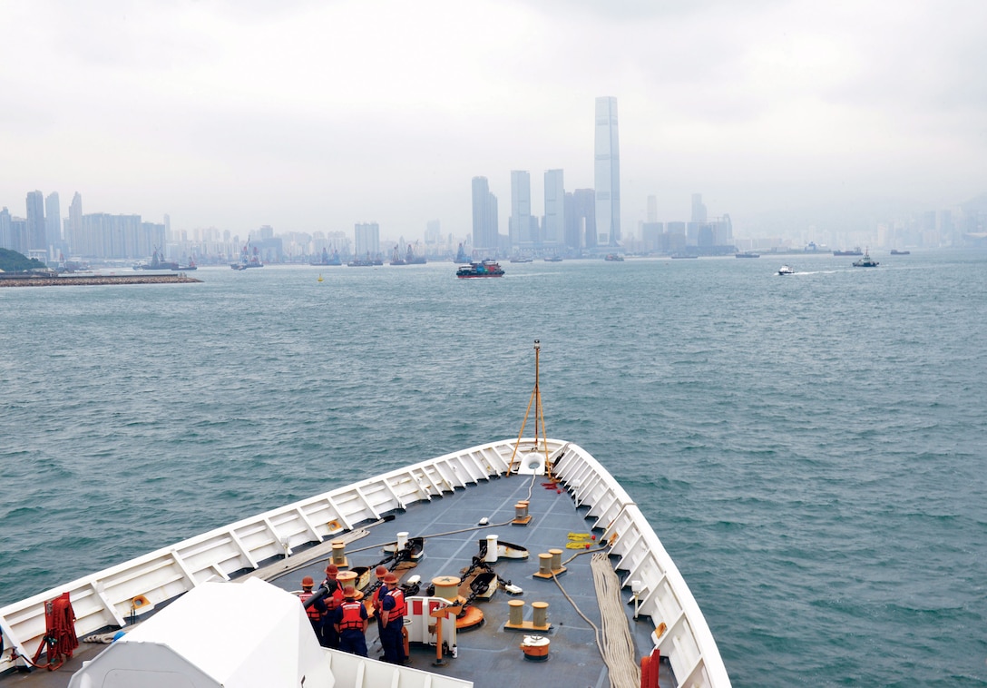 U.S. Coast Guard Cutter Bertholf crewmembers watch from cutter’s forecastle as Bertholf navigates toward Hong Kong