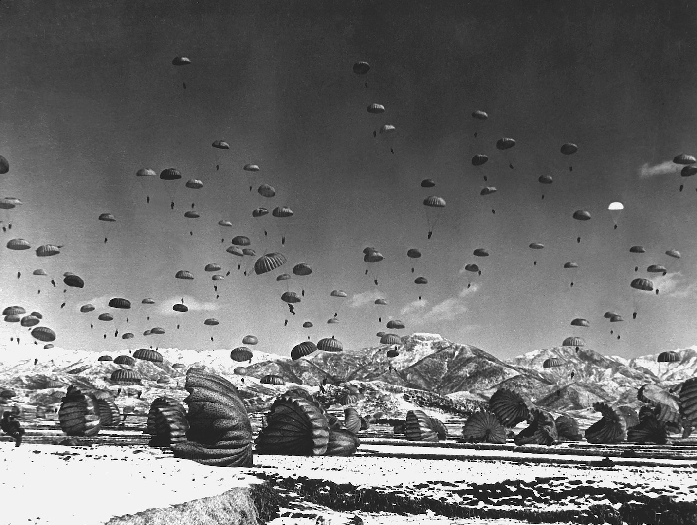 Men and equipment parachute to ground in operation conducted by United Nations airborne units, ca. 1951