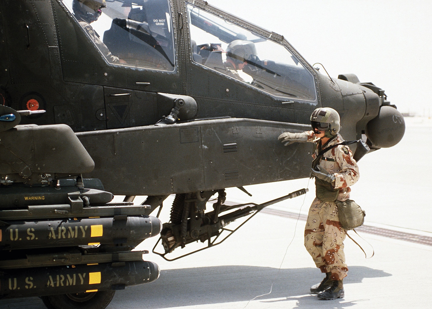 Crewman from 101st Airborne Division (Air Assault) stands beside AH-64A Apache helicopter