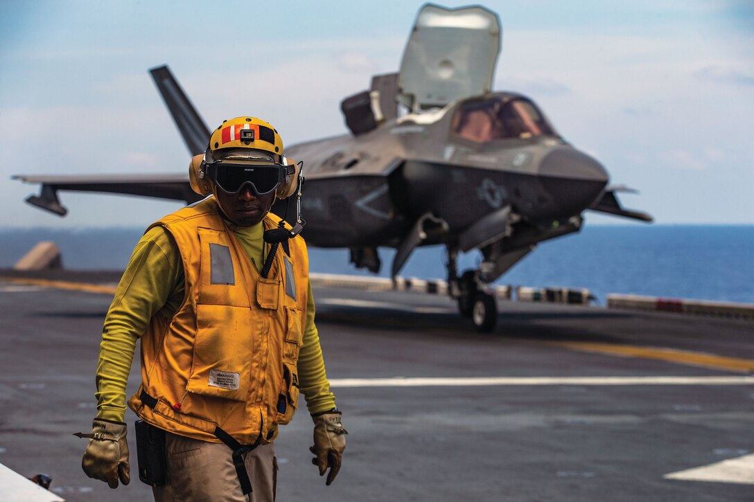 F-35B Lightning II fighter aircraft prepares to take off from flight deck of amphibious assault ship