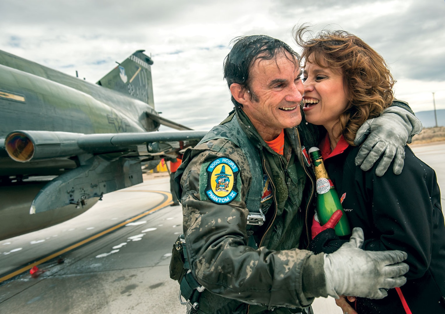 Civilian QF-4E Pilot/Controller Lieutenant Colonel Jim “Wam” Harkins, USAF (Ret.), hugs his wife, Annette, after being showered with champagne upon exiting cockpit of his McDonnell Douglas F-4 Phantom II