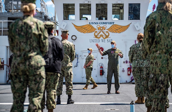 Captain Joseph O’Brien, mission commander of Task Force New York City, greets medical providers joining USNS Comfort, which is working with Javits New York Medical Station as integrated system to relieve city’s medical system, in support of U.S. Northern Command’s Defense Support of Civil Authorities as response to COVID-19 pandemic, April 15, 2020 (U.S. Navy/Scott Bigley)