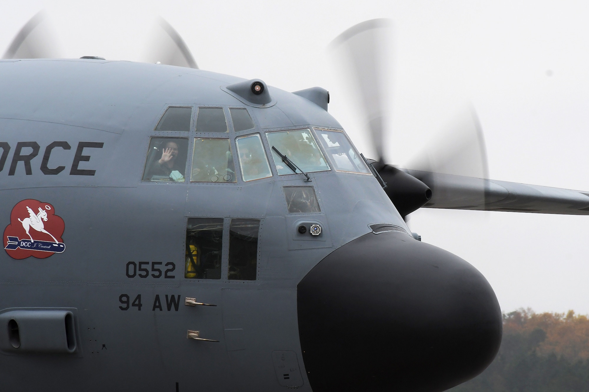 1st Lt. Lyndsy Harrison, a 700th Airlift Squadron navigator, waves from the flight deck of a C-130H3 Hercules at Dobbins Air Reserve Base, Nov. 10, 2020. She and Capt. Will Jones, 700th Airlift Squadron pilot, came up with the idea to get married on the back of a C-130 to honor their love of aviation. (Courtesy photo)