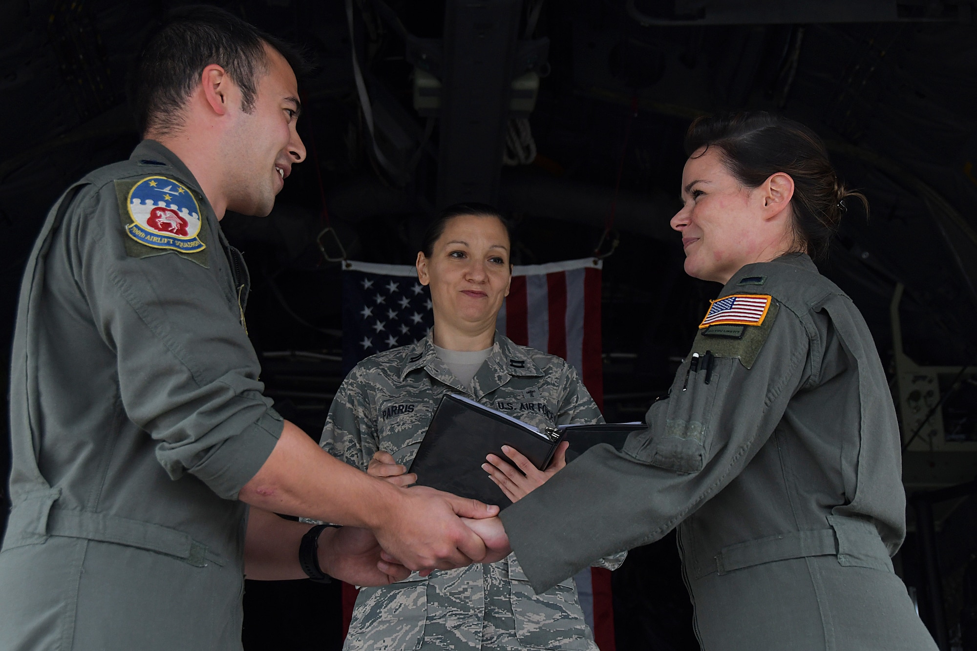 Capt. Will Jones, 700th Airlift Squadron pilot, recites his vows to 1st Lt. Lyndsy Harrison, a 700th AS navigator, during a wedding ceremony held on the back of a C-130H3 Hercules at Dobbins Air Reserve Base, Ga. on Nov. 10, 2020. The couple came up with the idea to get married on the back of a C-130 to honor their love of aviation. (U.S. Air Force photo/Andrew Park)