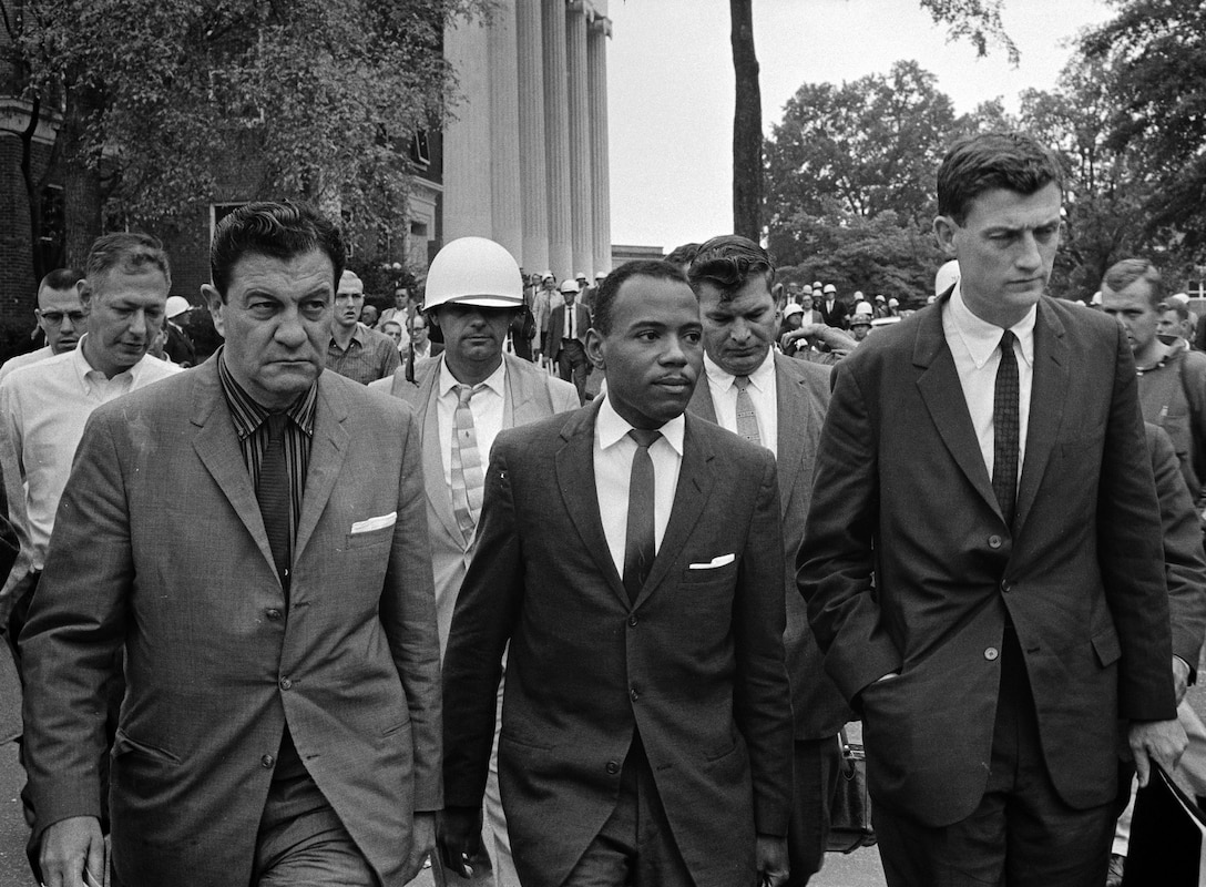James Meredith walks to class at University of Mississippi accompanied by U.S. Marshal James McShane (left) and John Doar of Justice Department, October 1, 1962