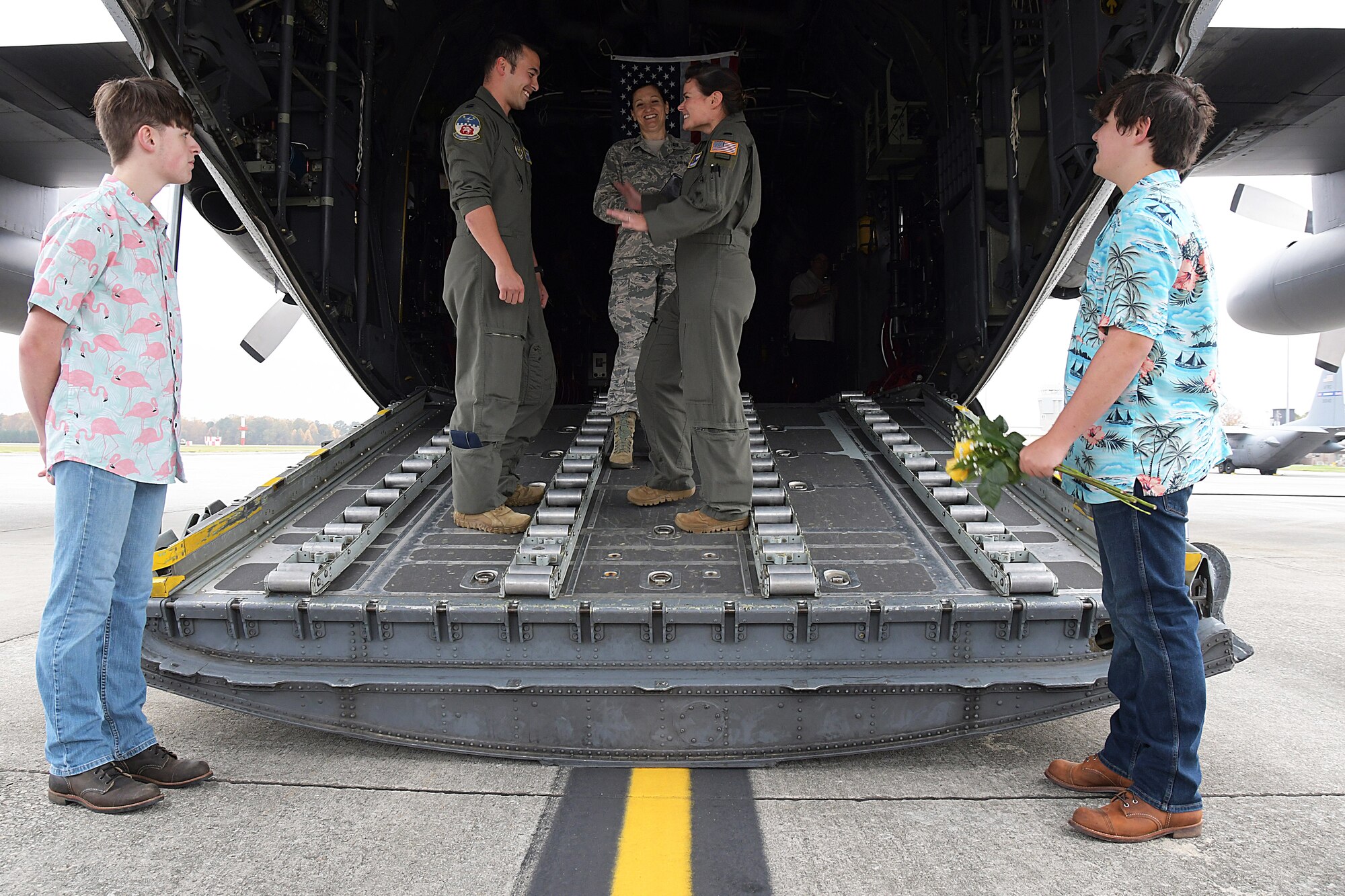 1st Lt. Lyndsy Harrison, a 700th Airlift Squadron navigator, smiles at the announcement that she and Capt. Will Jones, 700th AS pilot, are officially married during a ceremony on the back of a C-130H3 Hercules at Dobbins Air Reserve Base, Nov. 10, 2020. The couple came up with the idea to get married on the back of a C-130 to honor their love of aviation. (Courtesy photo)