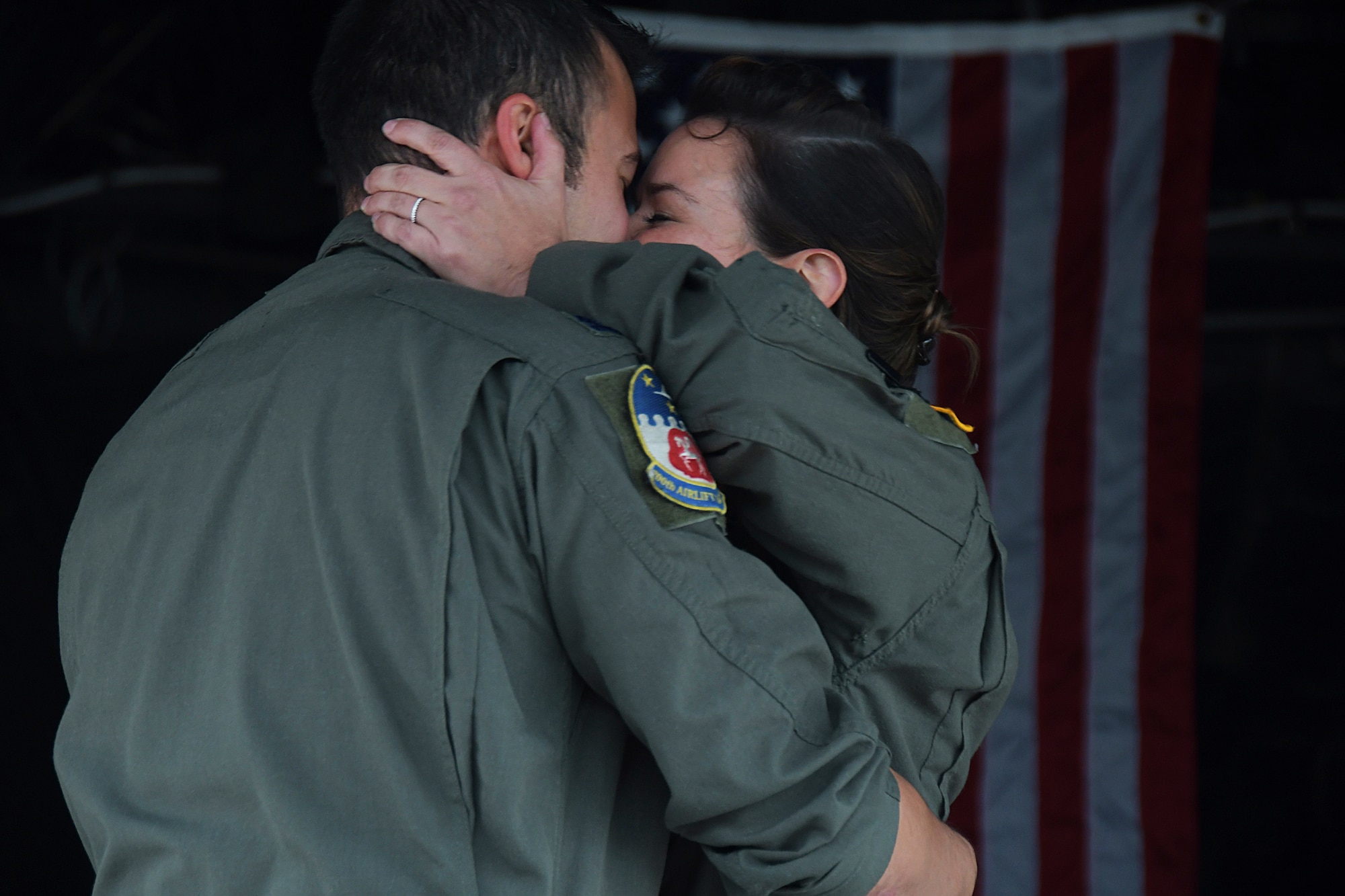 Capt. Will Jones, 700th Airlift Squadron pilot, and 1st Lt. Lyndsy Harrison, a 700th AS navigator, embrace during a wedding ceremony held on the back of a C-130H3 Hercules at Dobbins Air Reserve Base, Ga. on Nov. 10, 2020. The couple came up with the idea to get married on the back of a C-130 to honor their love of aviation. (U.S. Air Force photo/Andrew Park)