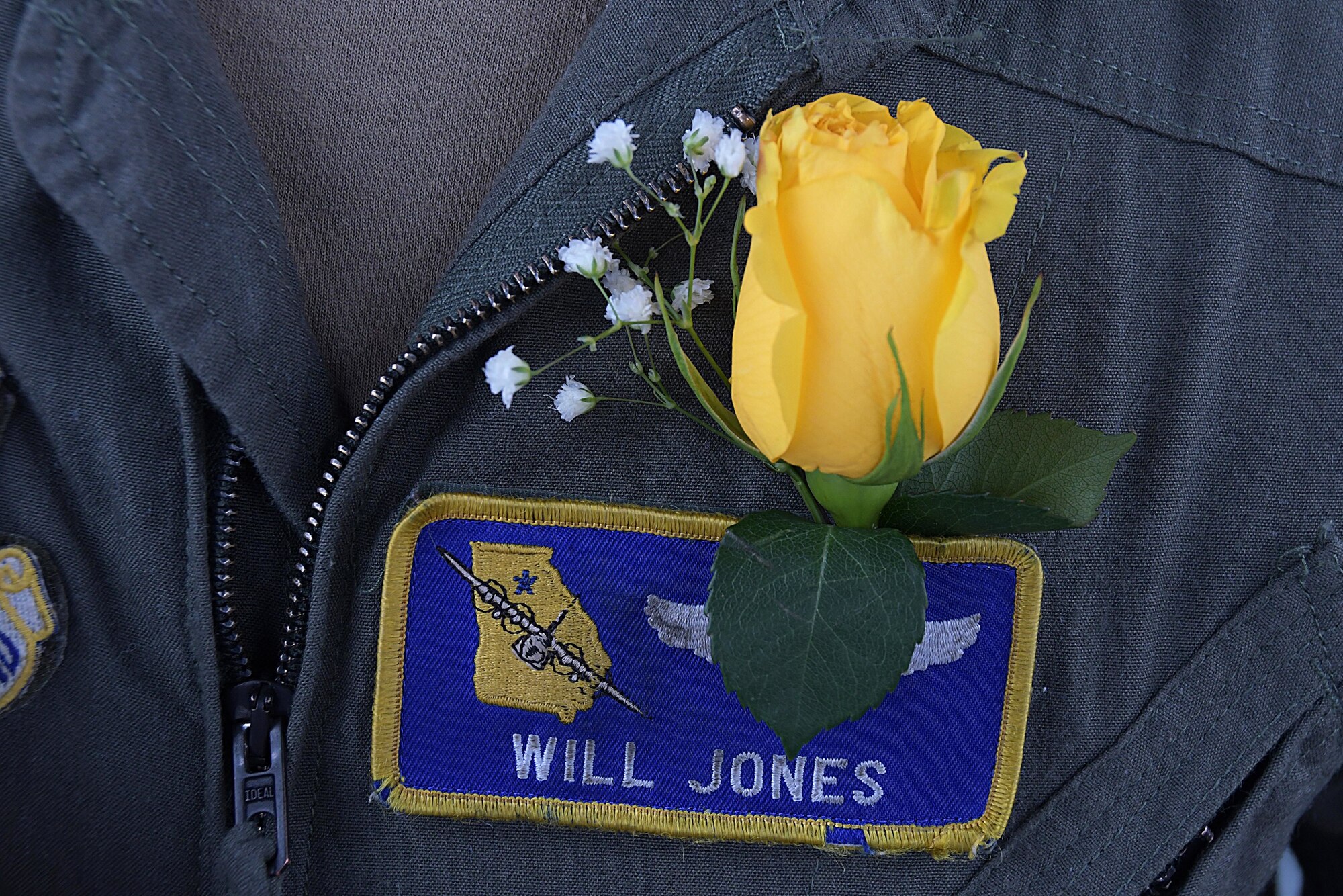 A yellow rose boutonniere sits above the name tape of Capt. Will Jones, 700th Airlift Squadron pilot, during a wedding ceremony on the back of a C-130H3 Hercules at Dobbins Air Reserve Base, Ga. on Nov. 10, 2020. He and 1st Lt. Lyndsy Harrison, a 700th Airlift Squadron navigator, came up with the idea to get married on the back of a C-130 to honor their love of aviation (U.S. Air Force photo/Andrew Park)