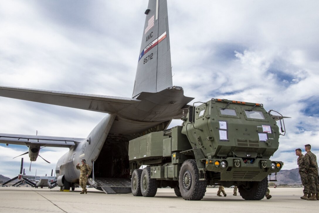 U.S. Marines and airmen load an M142 High Mobility Artillery Rocket System into a U.S. Air Force C-130J Super Hercules during a static loading operation on Marine Corps Air Station Camp Pendleton, California, Nov. 5, 2020. Over the course of two days, Marines with 1st Marine Division worked alongside the Air Force’s 39th Airlift Squadron to practice loading Marines and equipment into C-130J transport aircraft. The evolution served as loadmaster training for the airmen in preparation for their upcoming deployment, while providing an opportunity for familiarization training for the division’s mobility personnel. MCAS Camp Pendleton facilitates large aircraft like the C-130J, C-17 Globemaster III and C-5 Galaxy to further its mission of supporting strategic lift of equipment and deployment of Marines around the globe. (U.S. Marine Corps photo by Lance Cpl. Drake Nickels)