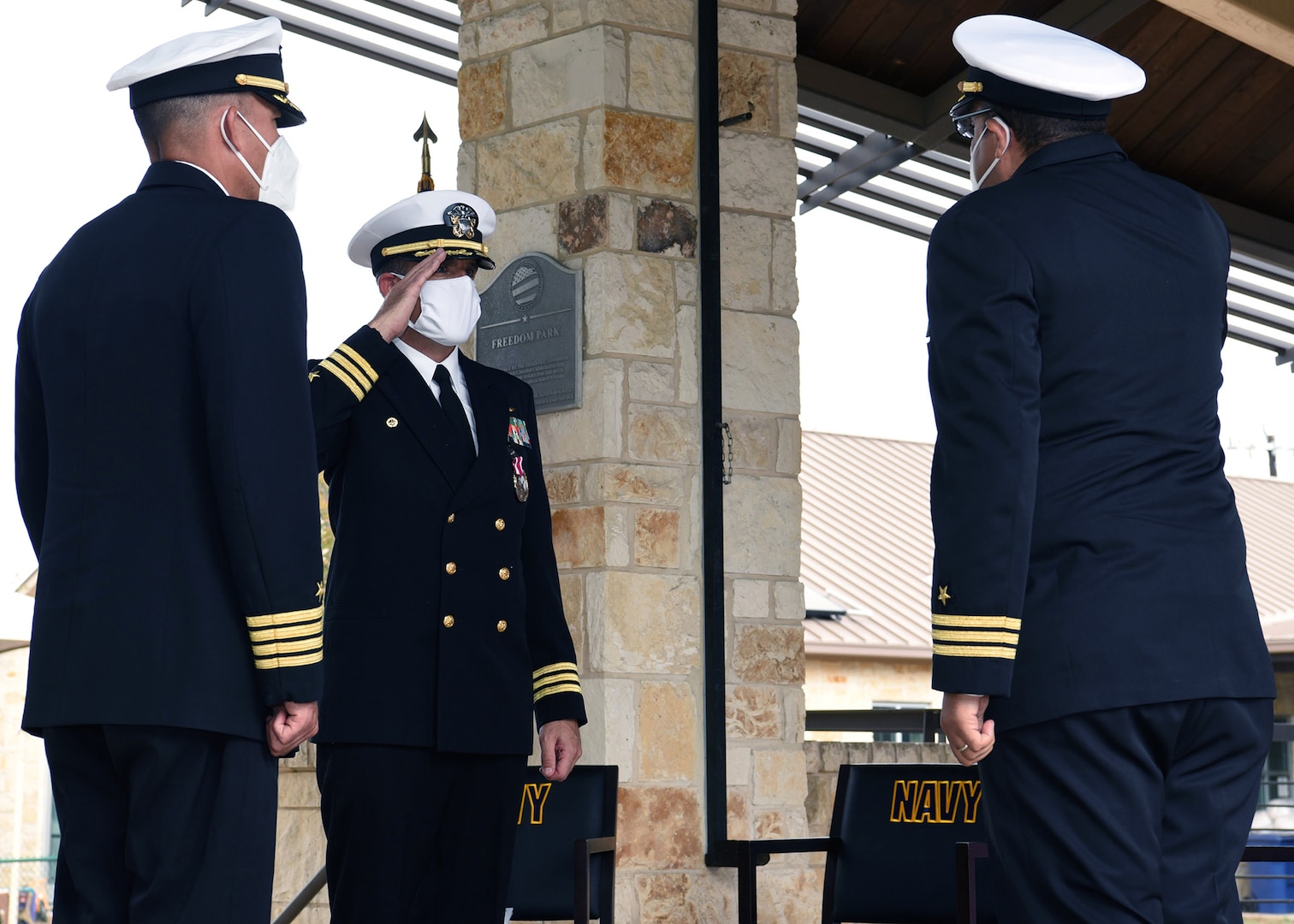 Cmdr. Nicholas Gamiz (center) hands over command of Navy Talent Acquisition Group San Antonio to Cmdr. Michael Files (right) during a change of command ceremony held at the Warrior & Family Support Center on Joint Base San Antonio-Fort Sam Houston Nov. 12. Presiding over the ceremony was Capt. Anthony Bayungan, (left), commodore, Region West, Navy Recruiting Command.