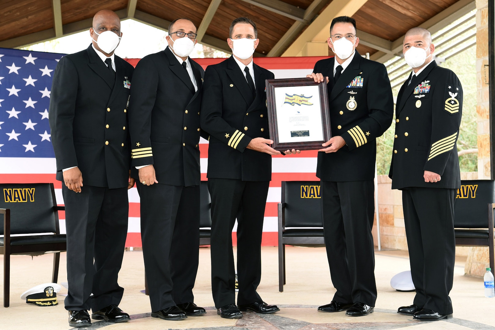 Capt. Anthony Bayungan (second from right), commodore, Region West, Navy Recruiting Command, presented the Gold “R” Award to the leadership of Navy Talent Acquisition Group San Antonio during a change of command ceremony held at the Warrior & Family Support Center at Joint Base San Antonio-Fort Sam Houston Nov. 12. The Gold “R” Award is presented to the top Navy Talent Acquistion Group, or NTAG, within NRC.