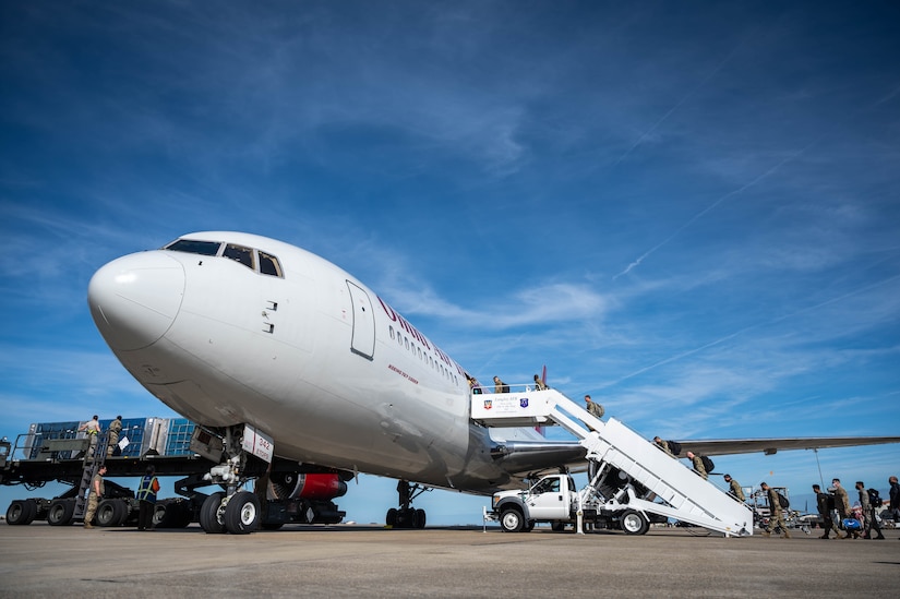 U.S. Air Force members from the 1st Fighter Wing board a Boeing 767-300ER.