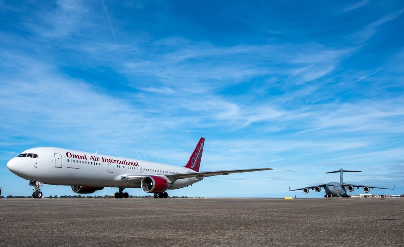 A Boeing 767-300ER and a U.S. Air Force C-17 Globemaster III aircraft assigned to Joint Base McGuire-Dix-Lakehurst get ready to taxi.