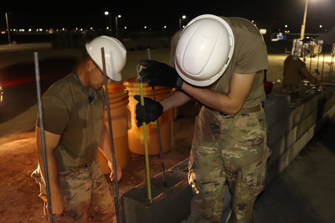Members of the 310th Engineering Detachment work on construction a Joint Air Ground Station building in Qatar. The building is being built using troop labor from a design from the U.S. Army Corps of Engineers Middle East District's Center of Standardization for Nonpermanent Facilities (COS). The COS maintains a library of off the shelf designs that can be adapted for almost any purpose. Using COS designs can save significant time and money in the construction process.