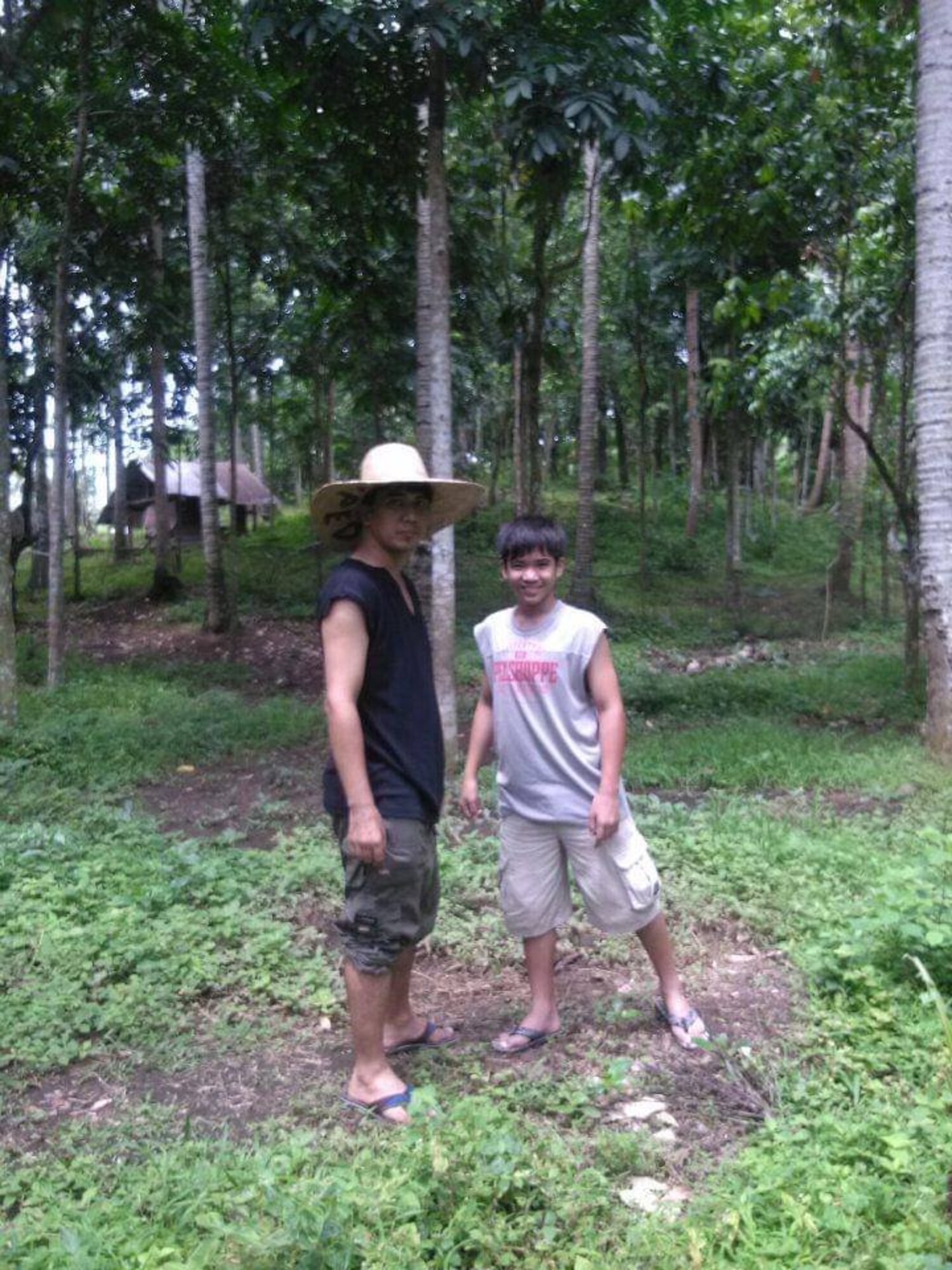 two people stand in a forest