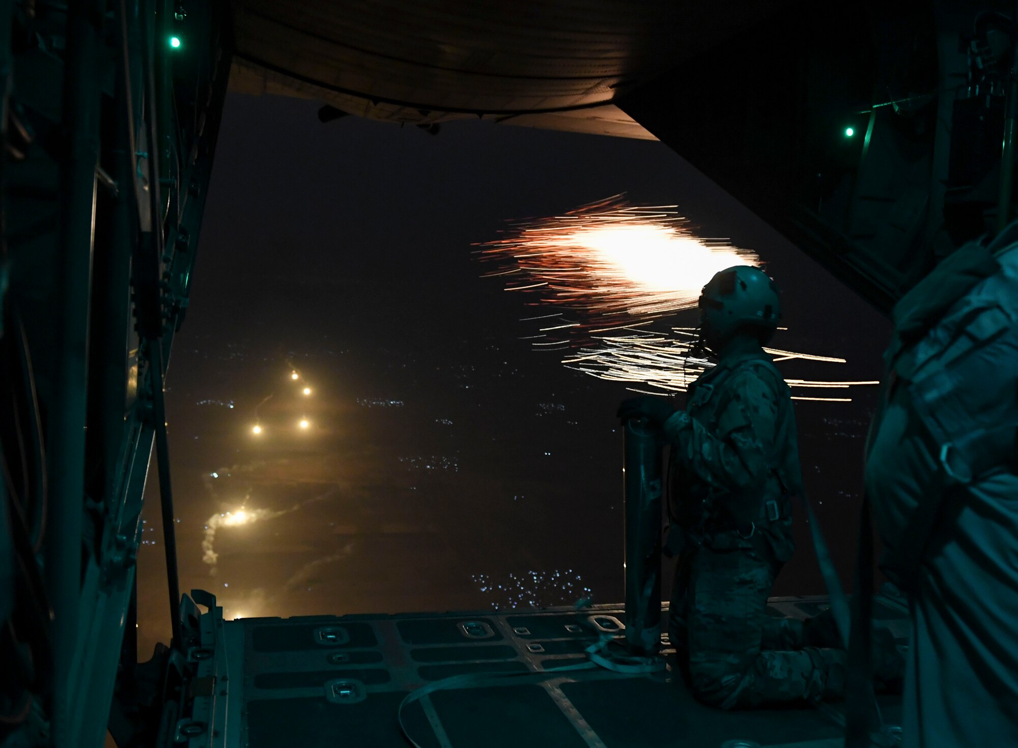 A U.S. Air Force Airman monitors illumination flares dropped from a C-130 Hercules Oct. 30, 2020.