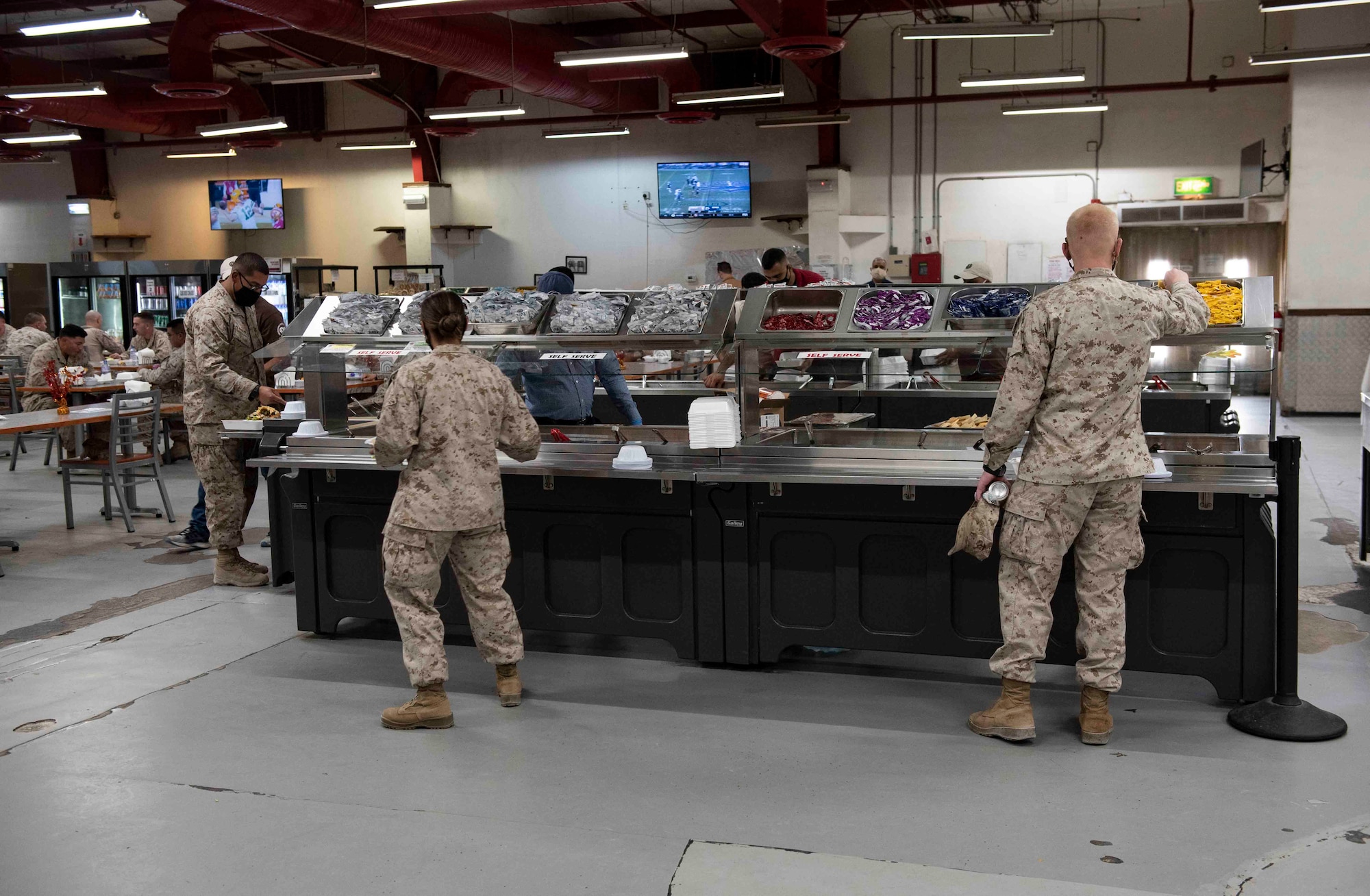 U.S. Marines serve themselves lunch in the dining facility at Ahmed Al Jaber Air Base, Kuwait, Nov. 6, 2020.