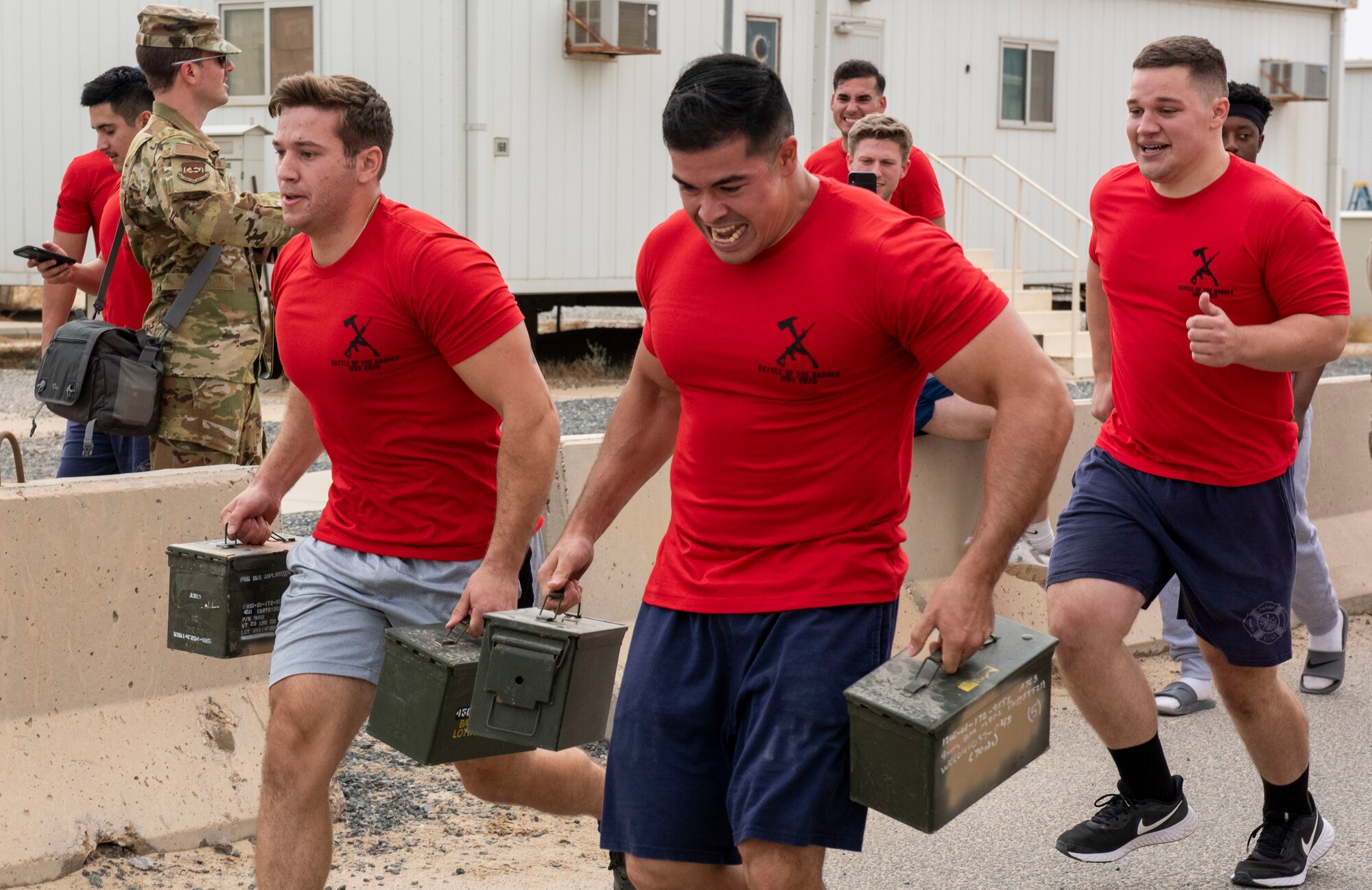 U.S. Air Force Airmen assigned to the 407th Expeditionary Civil Engineer Squadron sprint with ammunition containers during the Battle of the Badges event at Ahmed Al Jaber Air Base, Kuwait, Nov. 11, 2020.