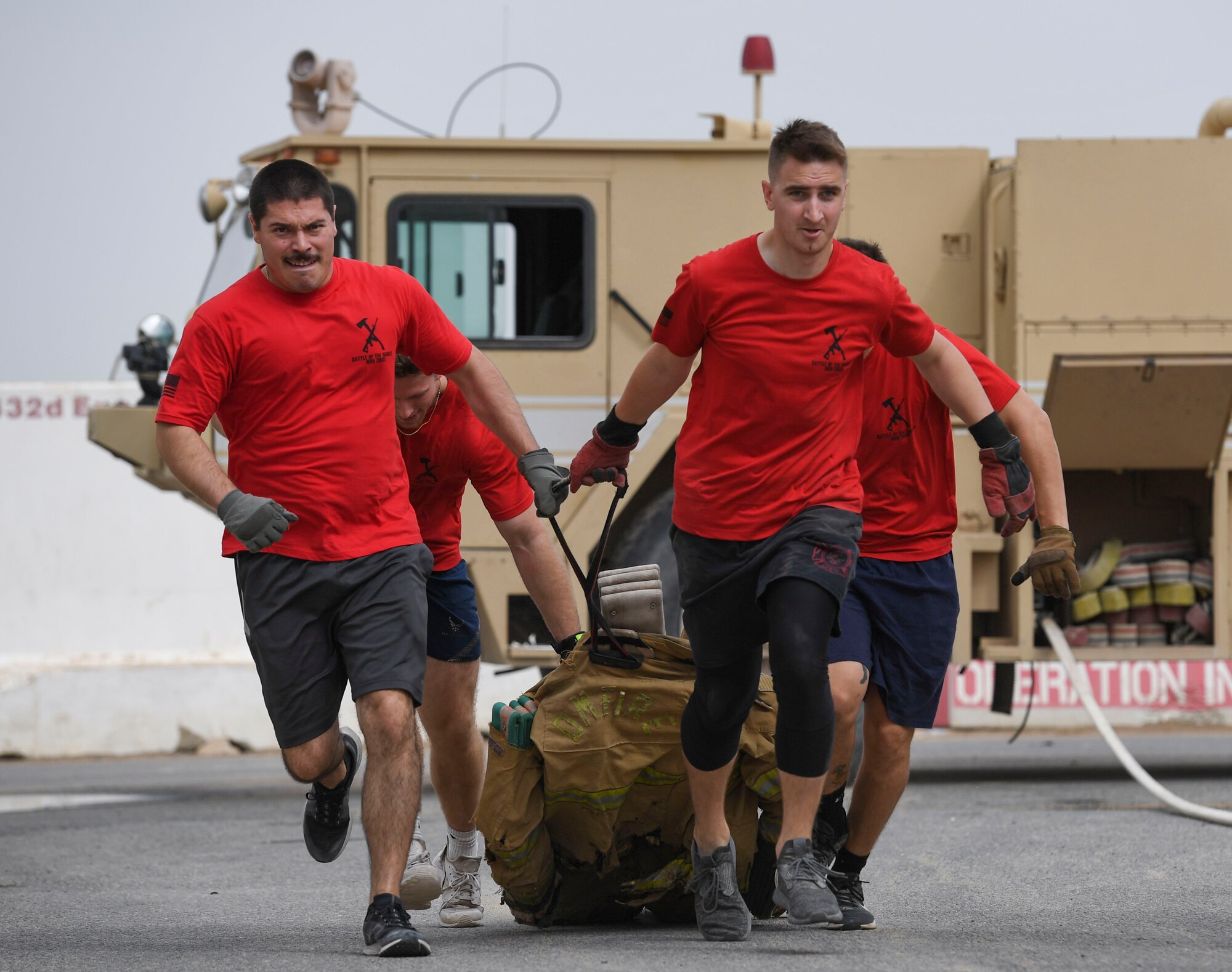 U.S. Air Force Airmen assigned to the 407th Expeditionary Civil Engineer Squadron drag a dummy during the Battle of the Badges event at Ahmed Al Jaber Air Base, Kuwait, Nov. 11, 2020.